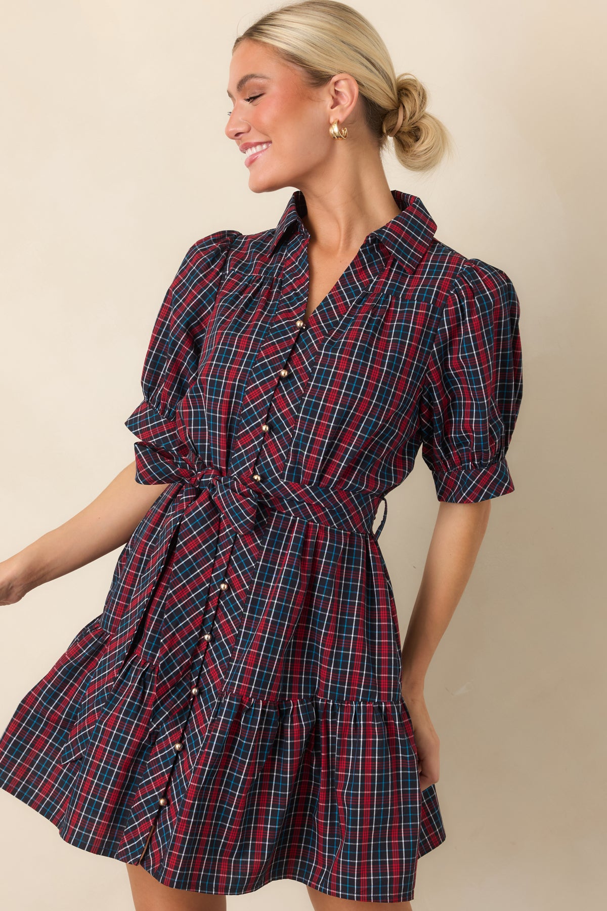 Plaid cotton mini dress highlighting its collared neckline, button-front closure, and waist-defining matching belt.

