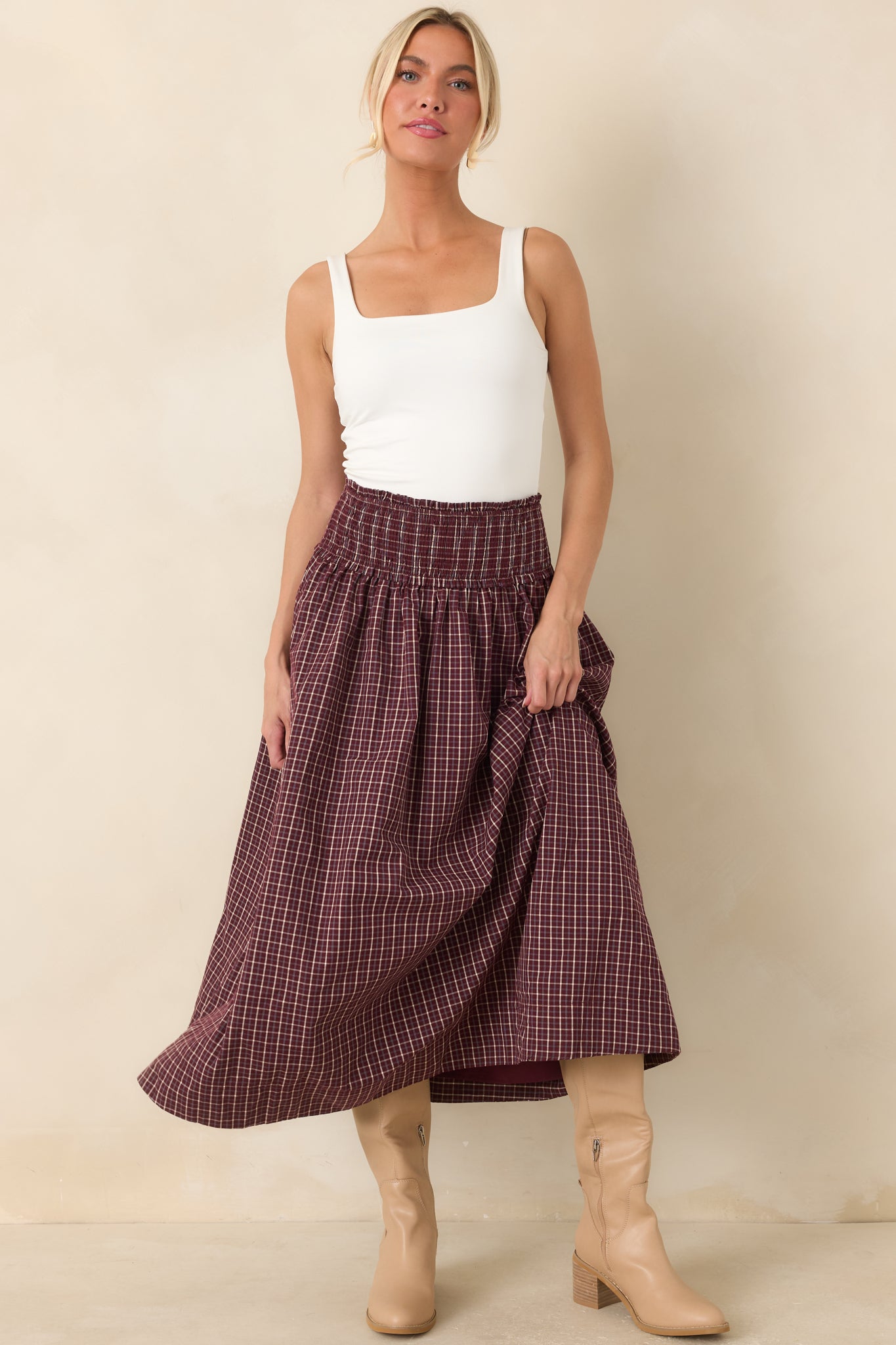Full-length plaid skirt with burgundy, ivory, and light blue tones, a stretchy smocked waistband, and a gathered silhouette.