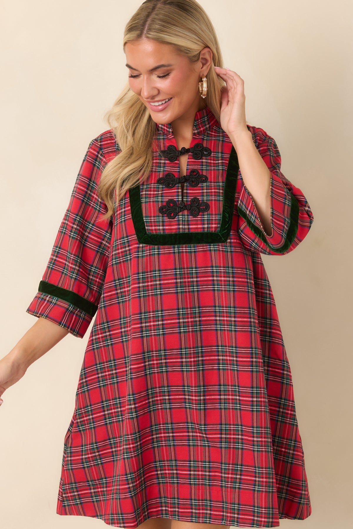 Plaid mini dress with black braided frog closures arranged down the front beneath a contrasting velvet-trimmed collar.