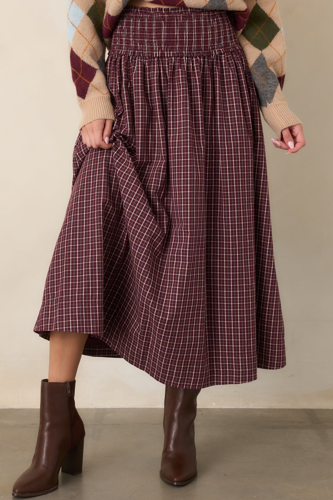 Close view of the plaid maxi skirt highlighting the wide smocked waistband and delicate ruffle trim.