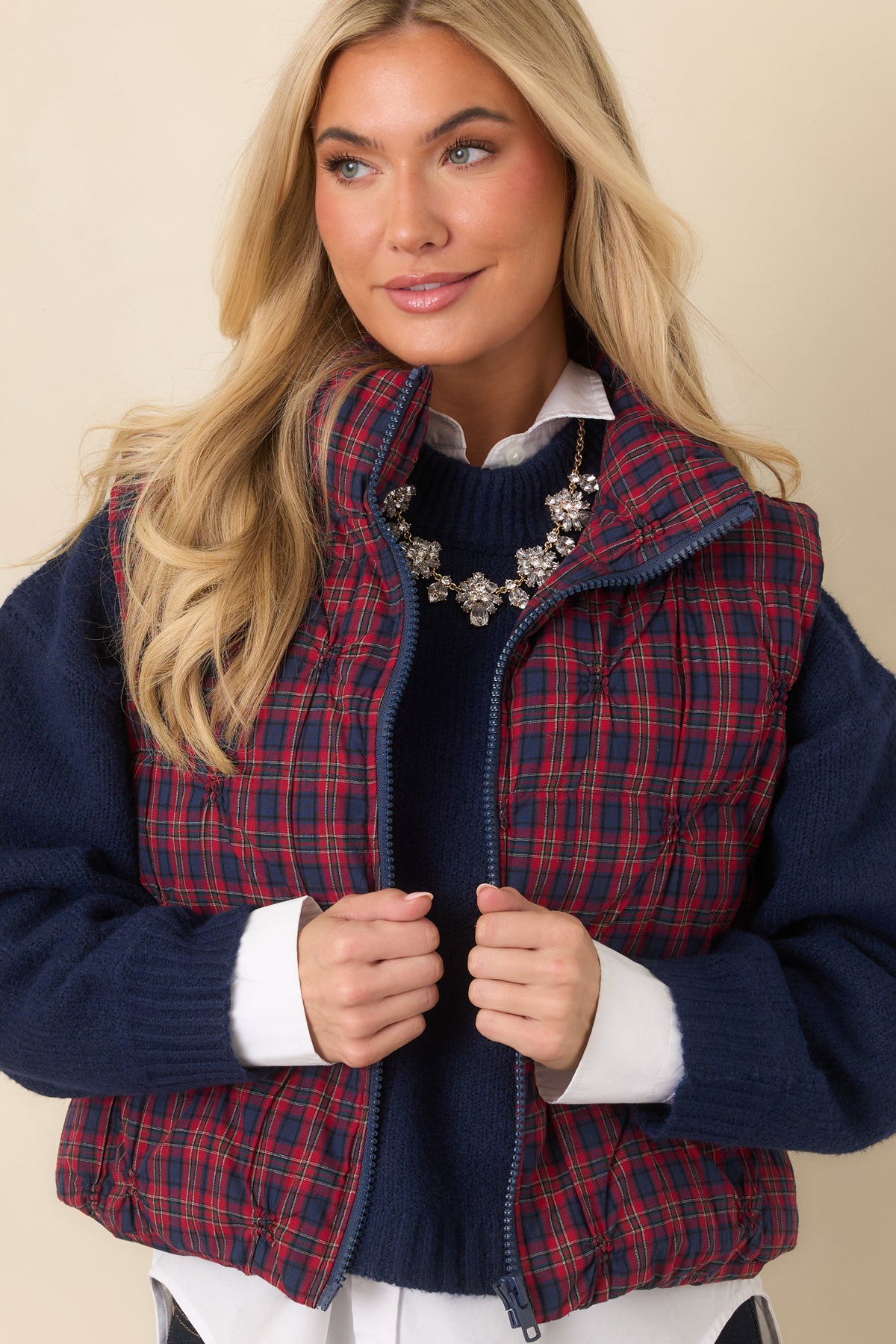 Stand collar and navy front zipper on the plaid quilted cotton vest.