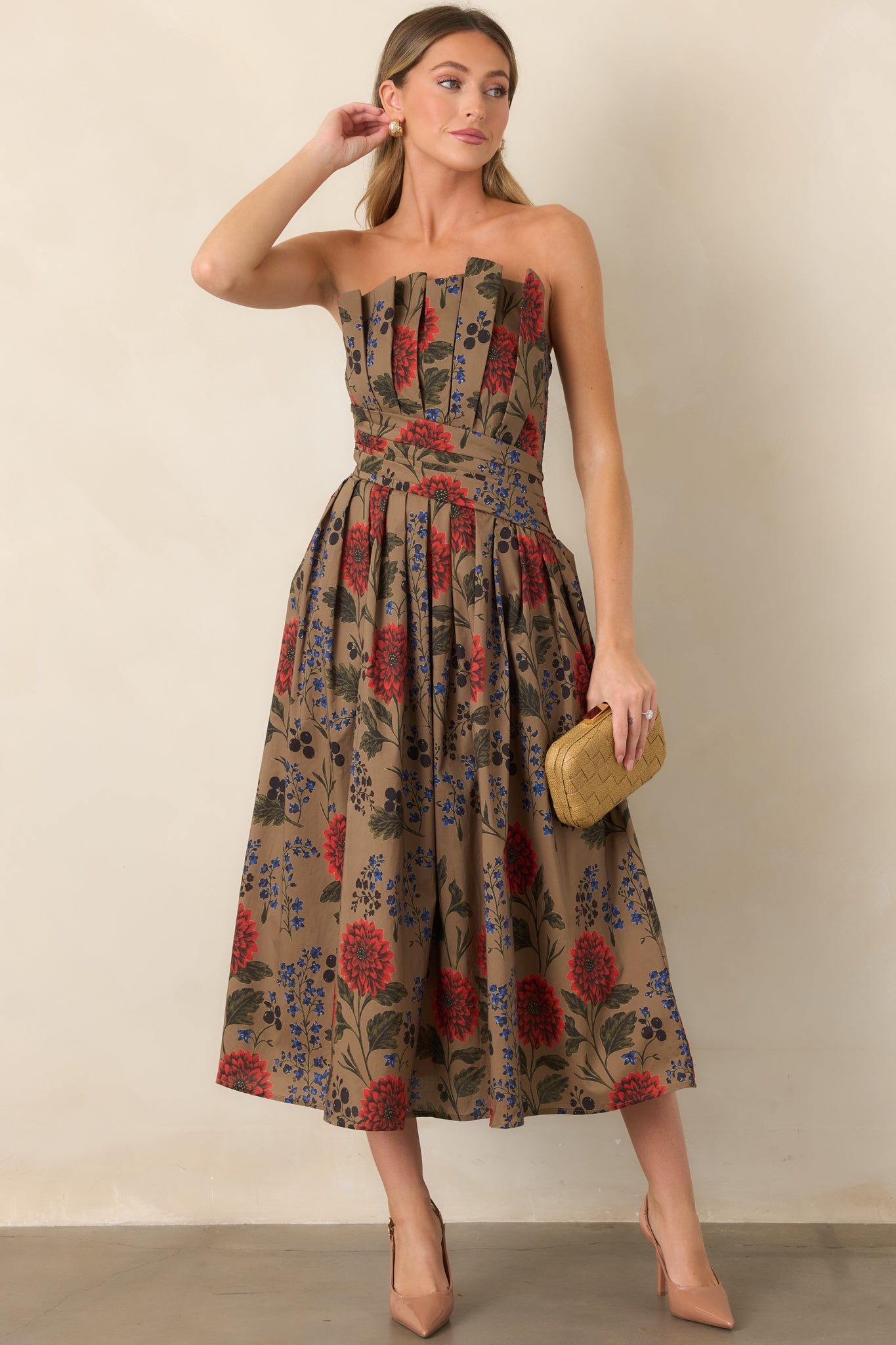 Floral midi dress with a pleated strapless bodice, shaped waist, and voluminous skirt featuring colorful blooms and leafy accents.