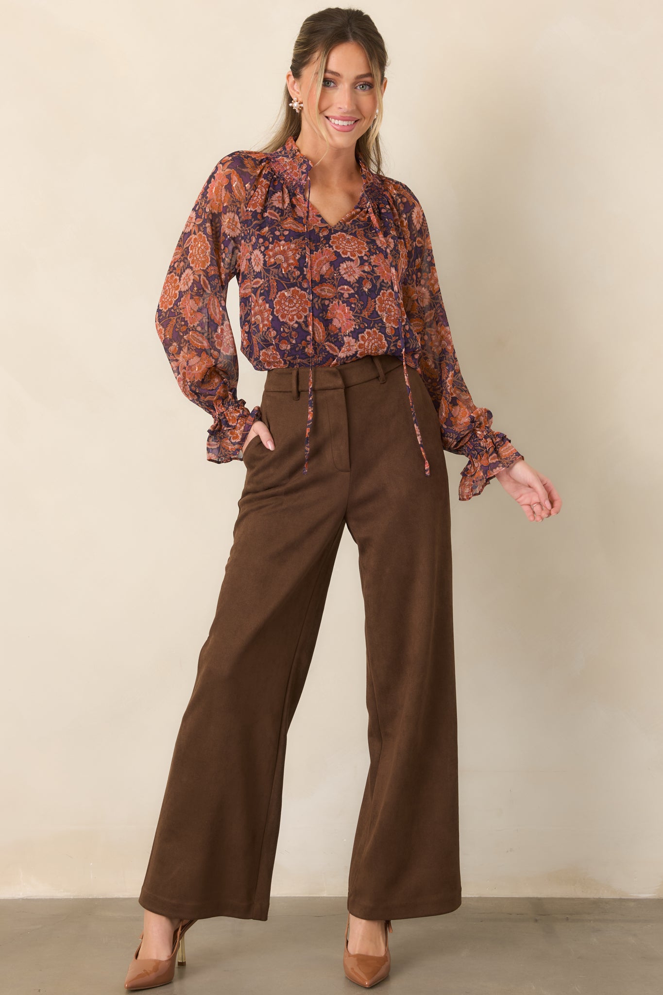 Rich plum floral top featuring a sheer overlay, lined bodice, ruffled split neckline, and long sheer sleeves.