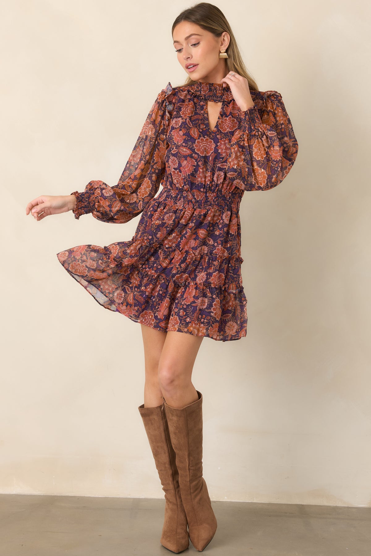 Sheer floral mini dress showcasing rust, coral, and muted pink blooms, a defined smocked waist, and softly tiered skirt.