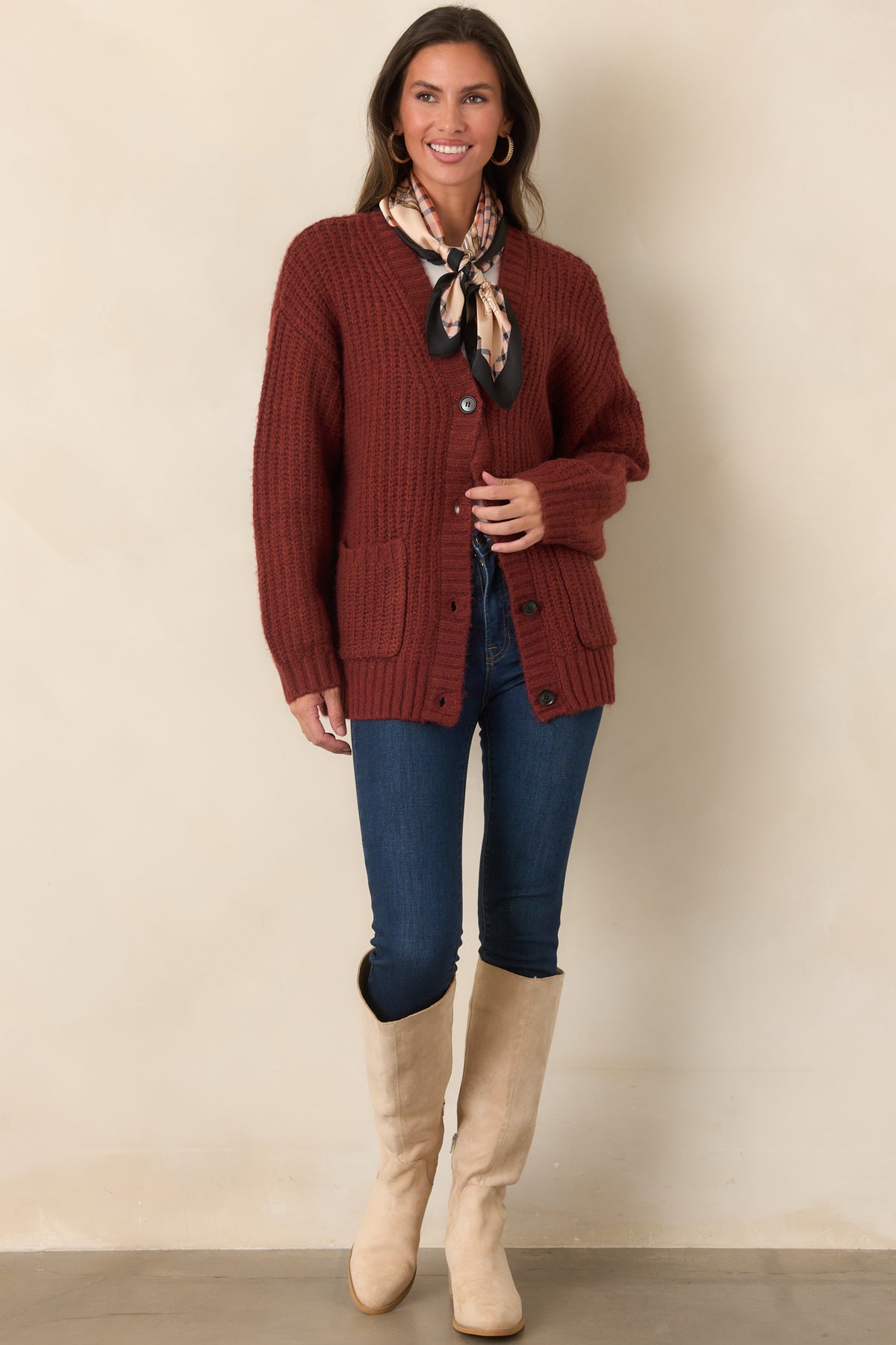 Plush cardigan showcasing the open V-neckline, dropped shoulder construction, and straight hip-length hem with ribbed trim.