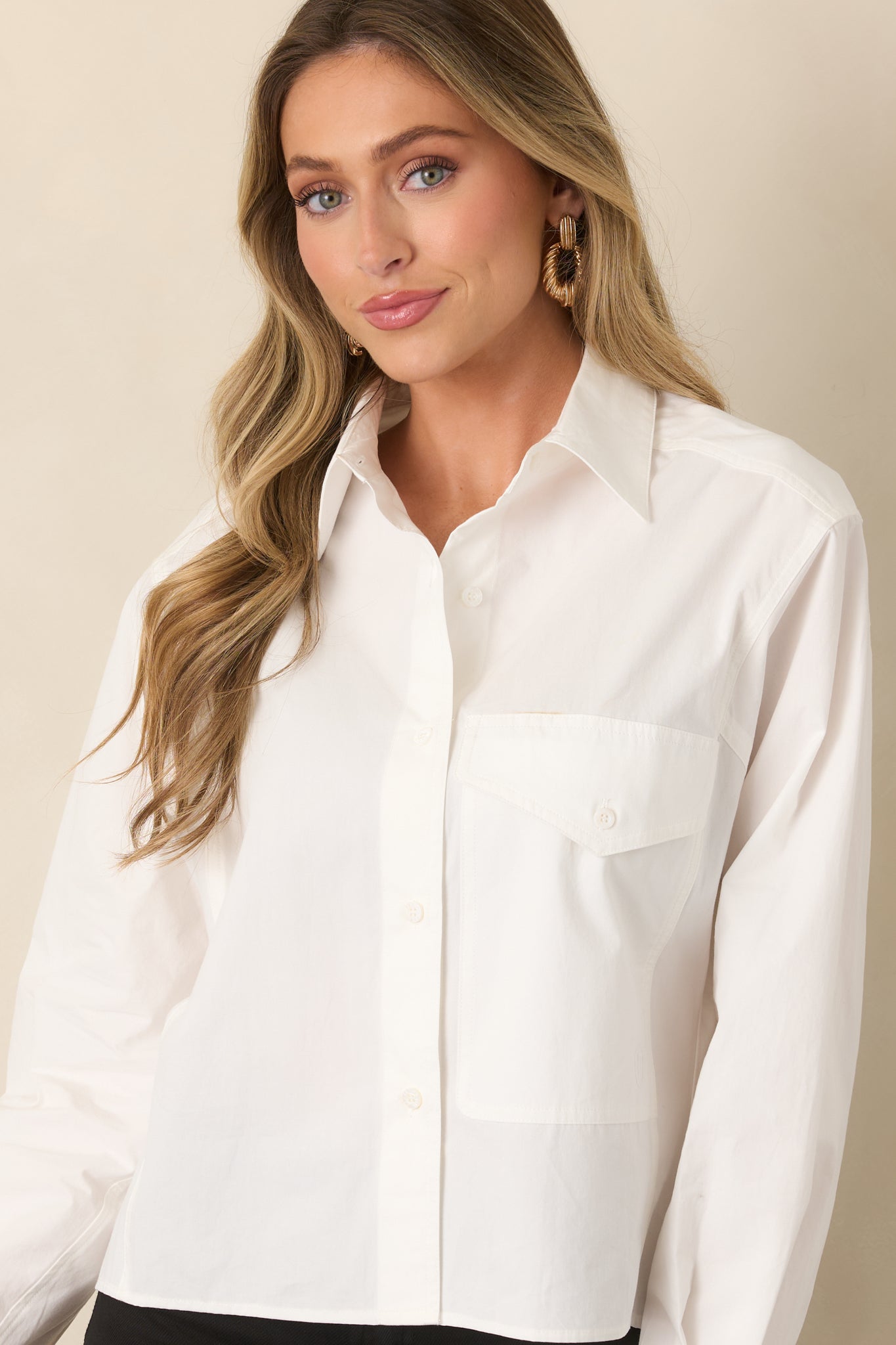 Close view of the pointed collar, full button front, and oversized flap chest pocket on the relaxed top.