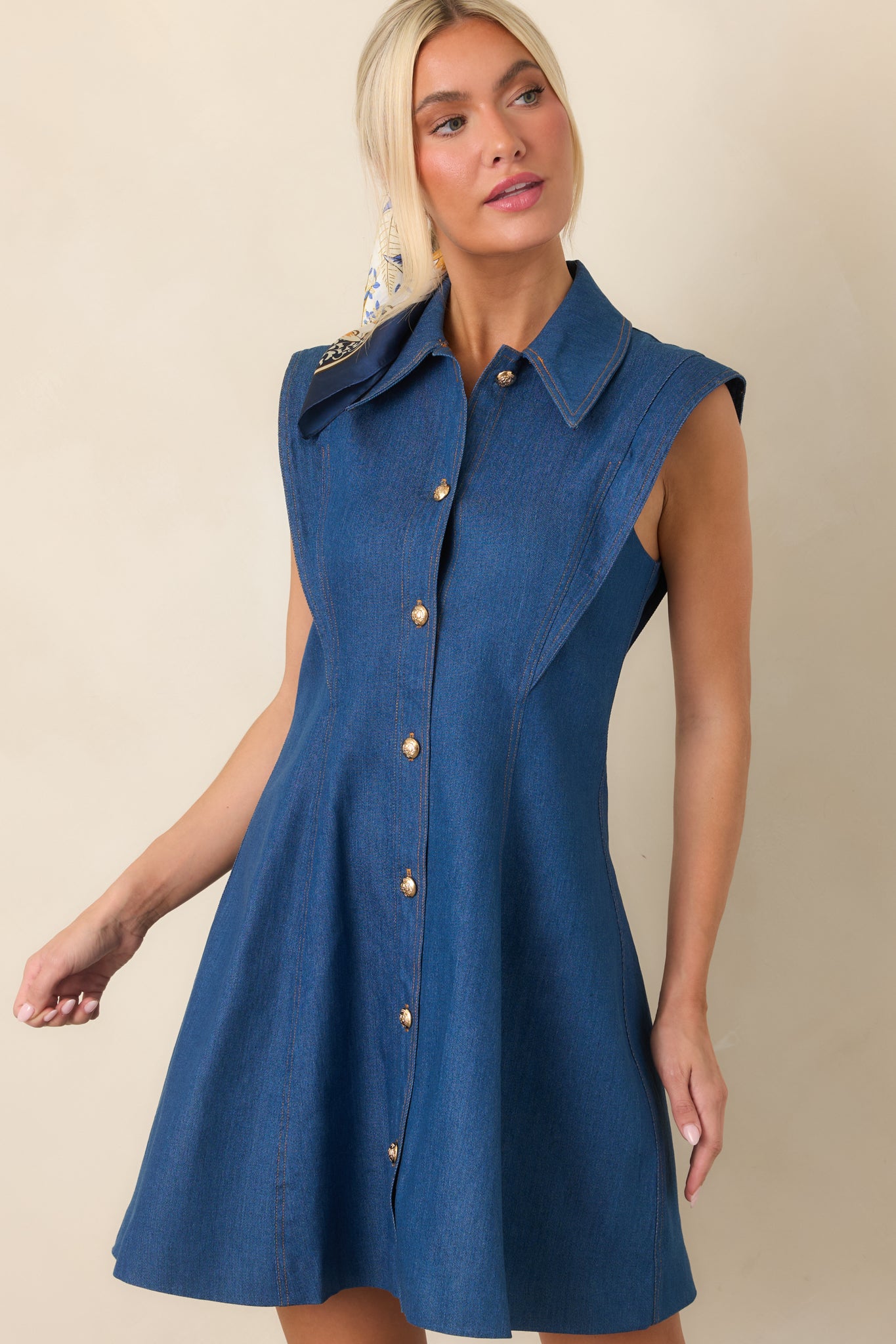 Front detail of the mini dress highlighting the pointed collar, gold-tone button closure, and structured cotton-blend fabric.