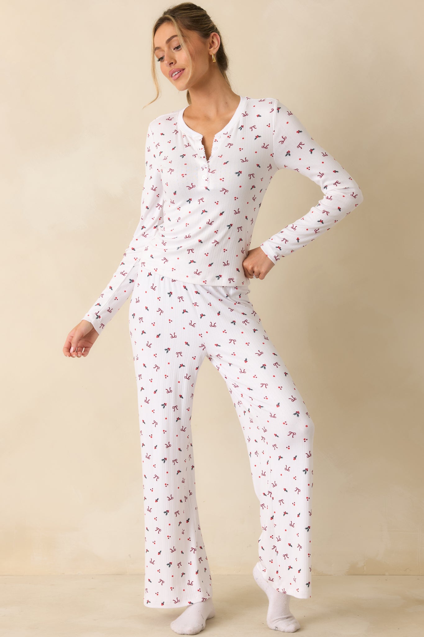 Silky Pointelle knit henley with long sleeves, high button-front placket, and seasonal holly-and-bow print.