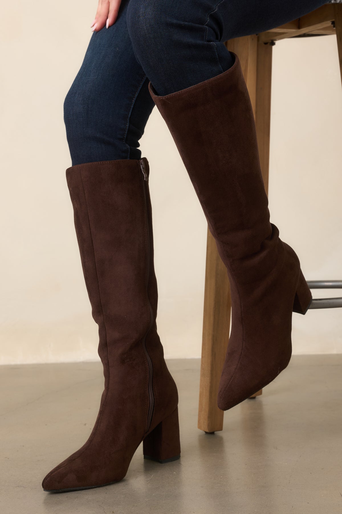 Polished brown knee-high boots with a fitted shaft, full-length side zipper, and covered block heel.