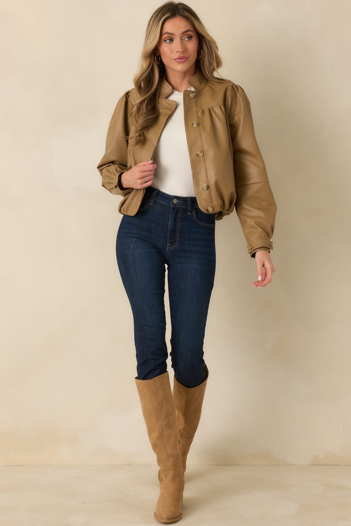 Polished caramel jacket featuring geometric quilted stitching along the button-front closure and an elasticized hem that defines the shape.
