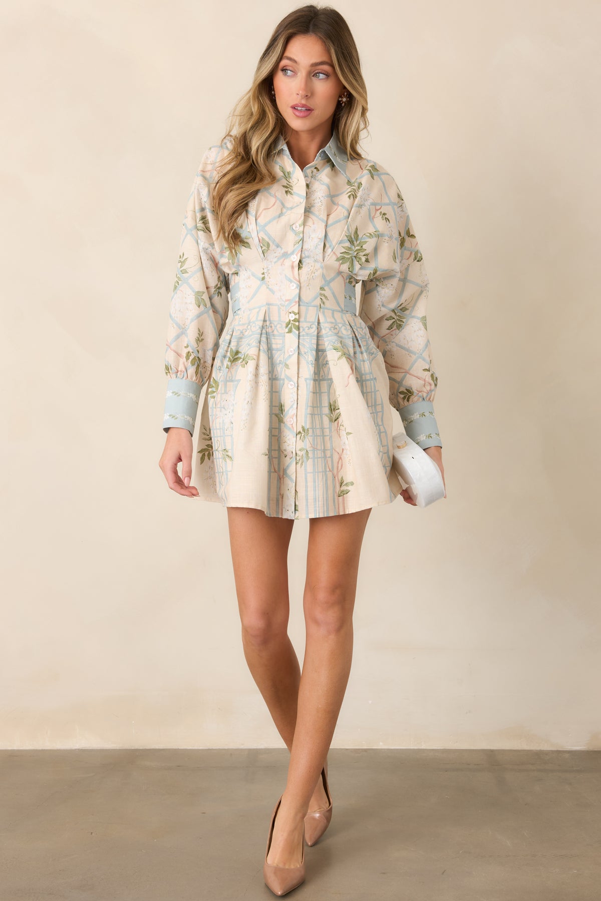 Polished shirt dress showcasing a traditional collar, functional button placket, long sleeves, buttoned cuffs, and a neatly shaped waistline.