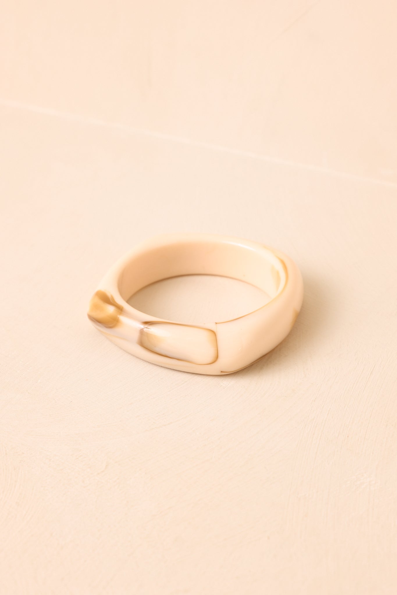 Close-up of the bracelet showcasing the polished resin finish and smooth, curved detailing.
