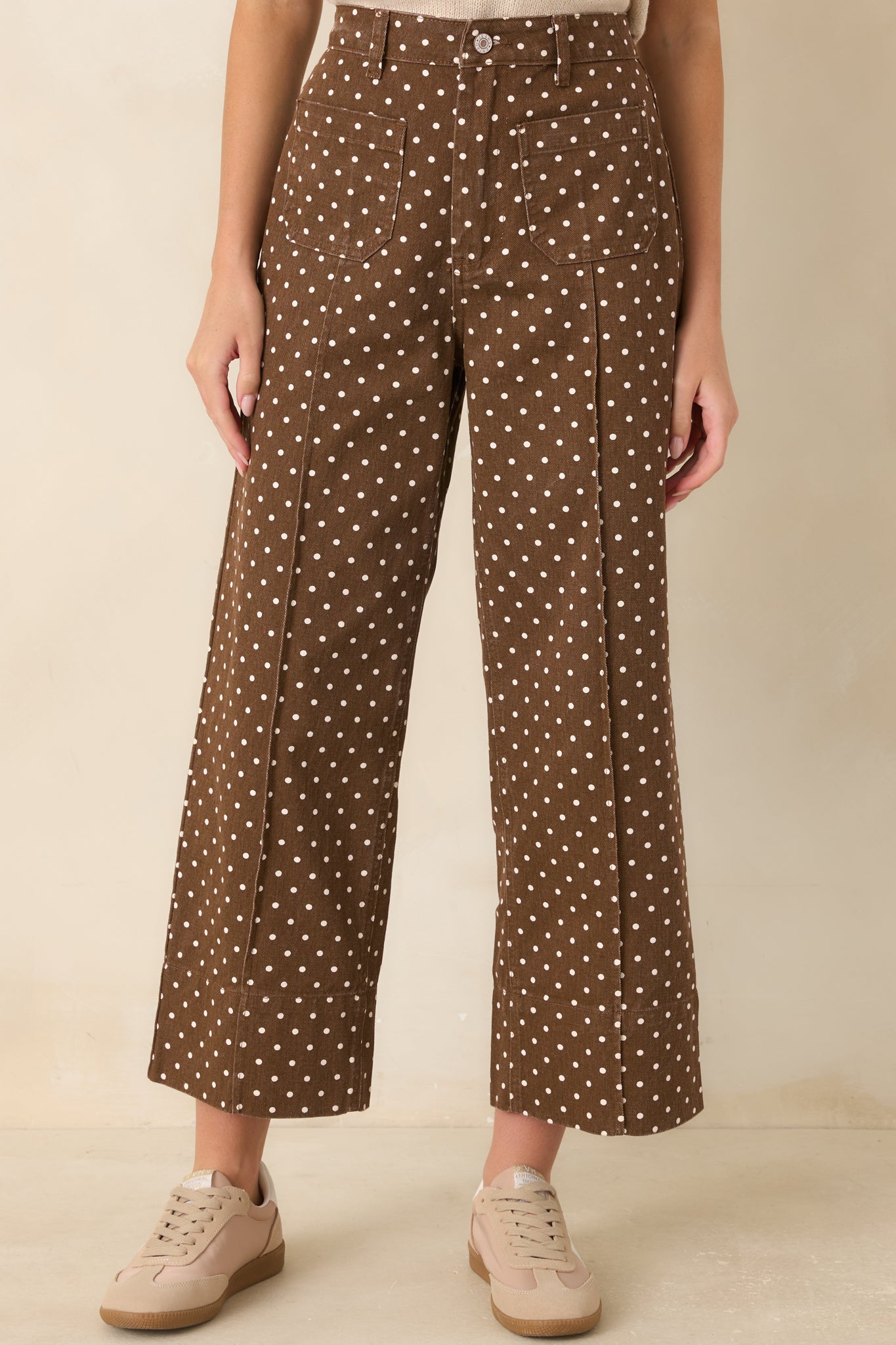 The front of these polka dot pants highlights the waistband, seams, and oversized patch pockets.