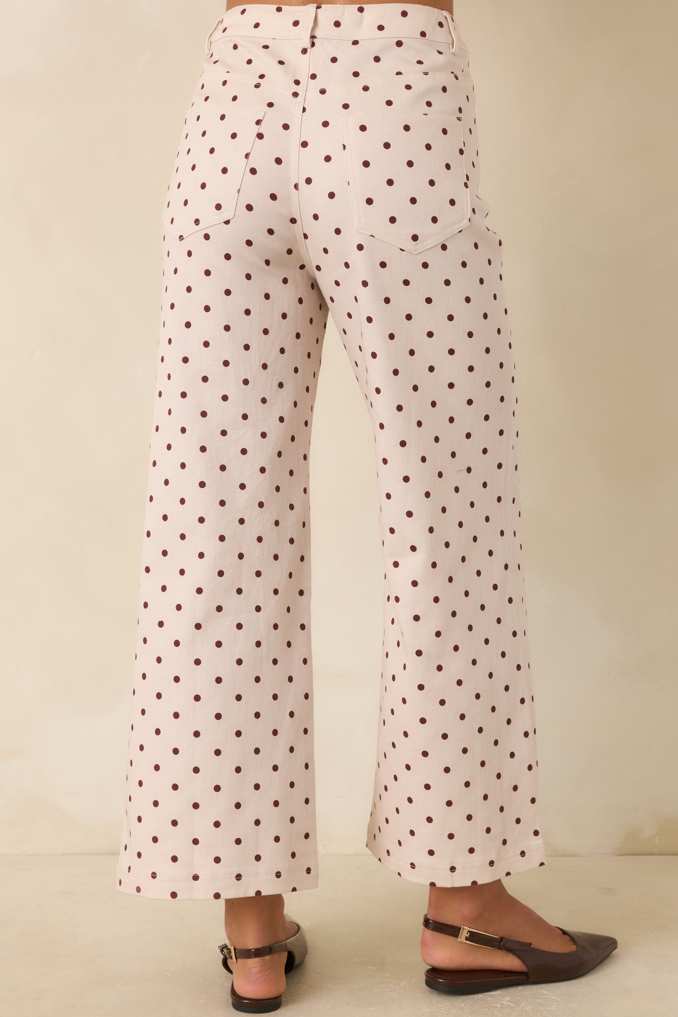 Rear view of the wide-leg pants featuring back patch pockets, high-rise fit, and full-length silhouette.