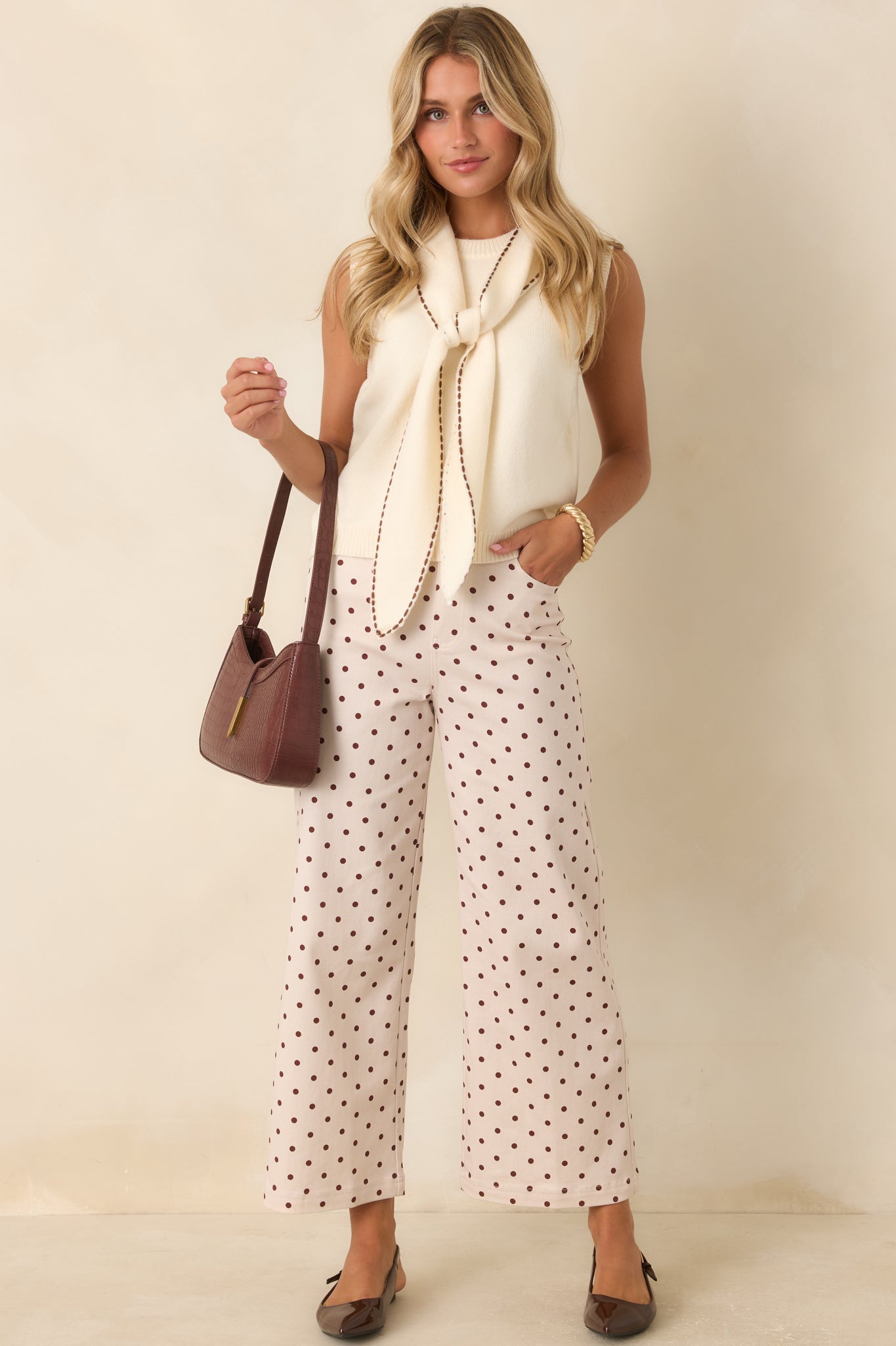 Wide-leg pants showcasing brown polka dots, functional patch pockets, belt loops, and timeless utility details.
