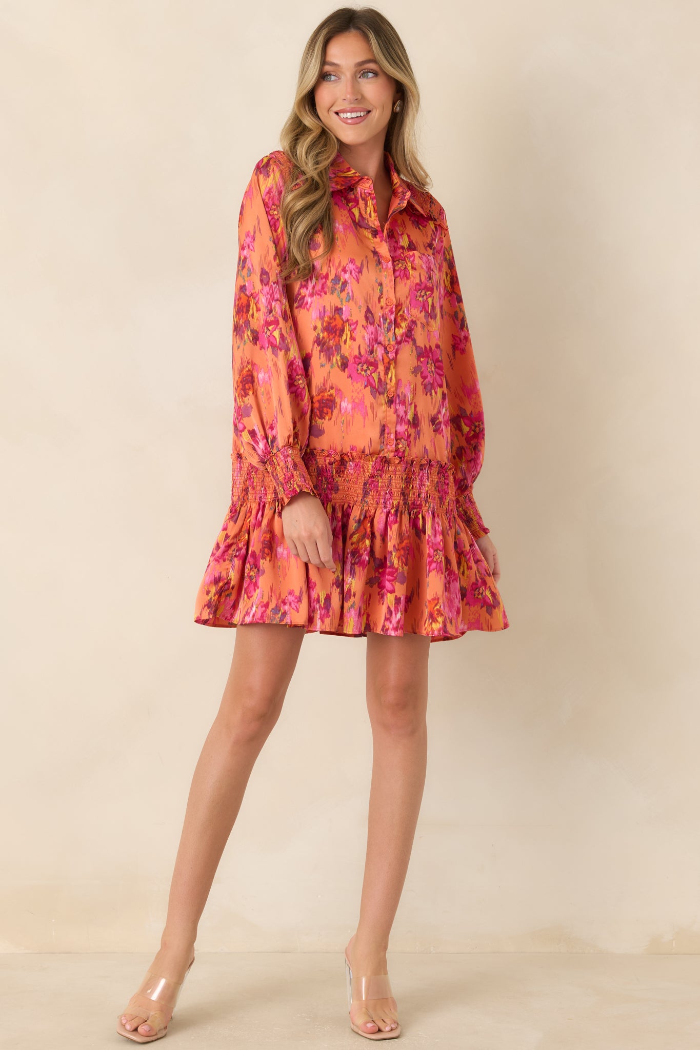 Smooth satin mini dress showcasing a button-front collar, voluminous balloon sleeves, smocked cuffs, and a relaxed drop-waist silhouette.