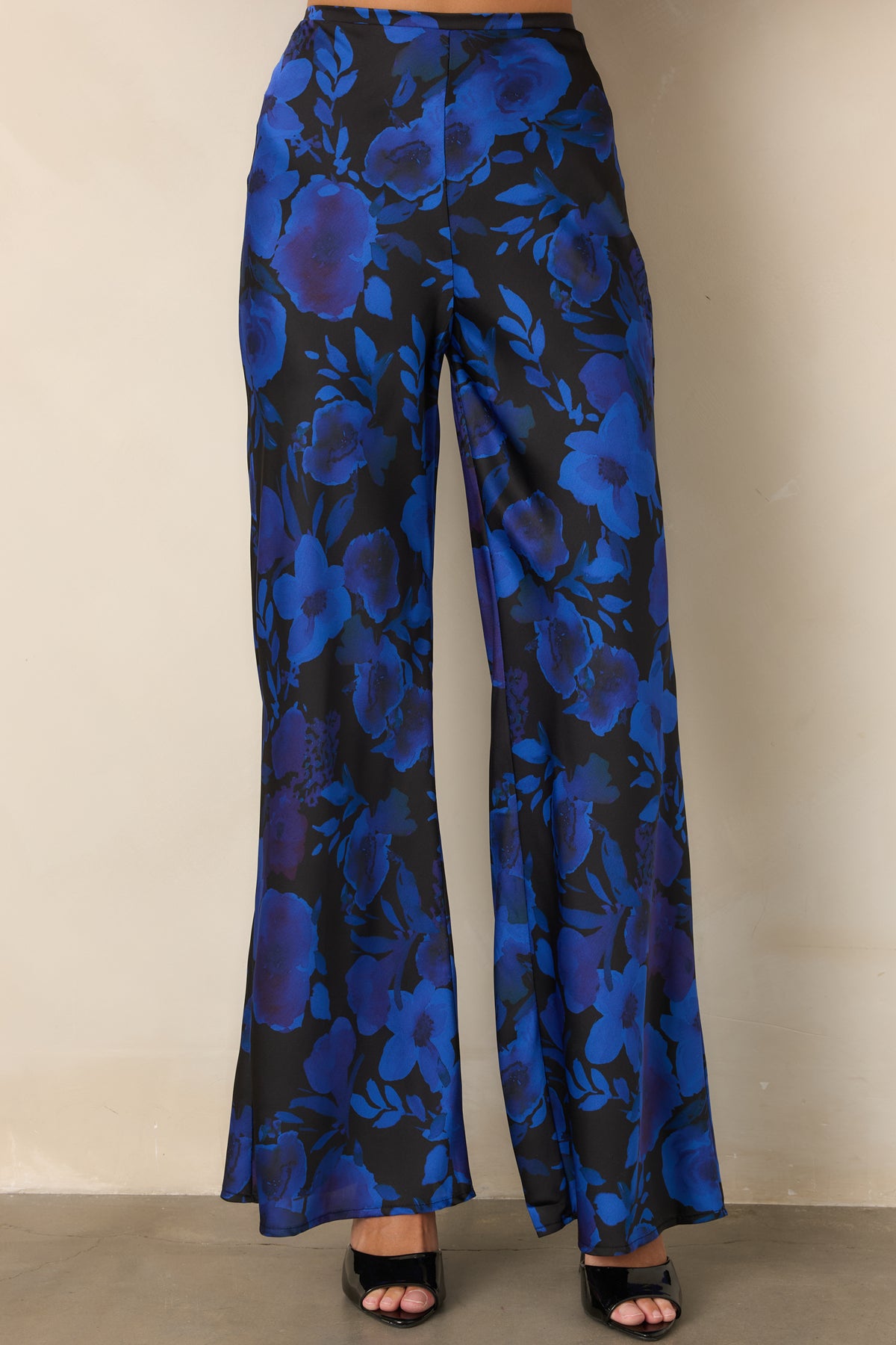 Polyester satin pants featuring a polished high-rise waistband and vibrant cobalt and violet floral pattern.