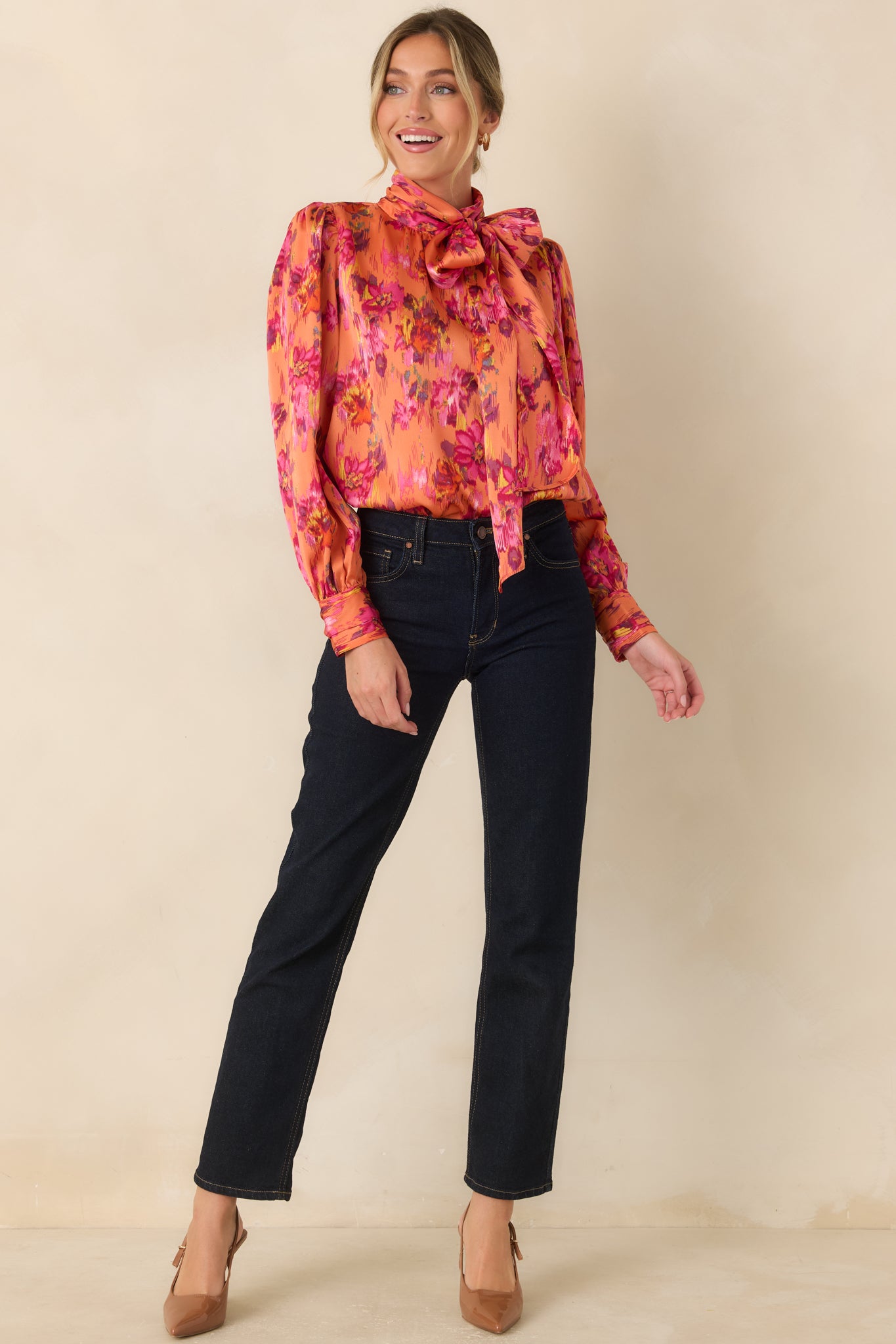Polyester satin top with a flowing drape, dramatic neck tie, subtly gathered shoulders, and long balloon sleeves finished with buttoned cuffs.