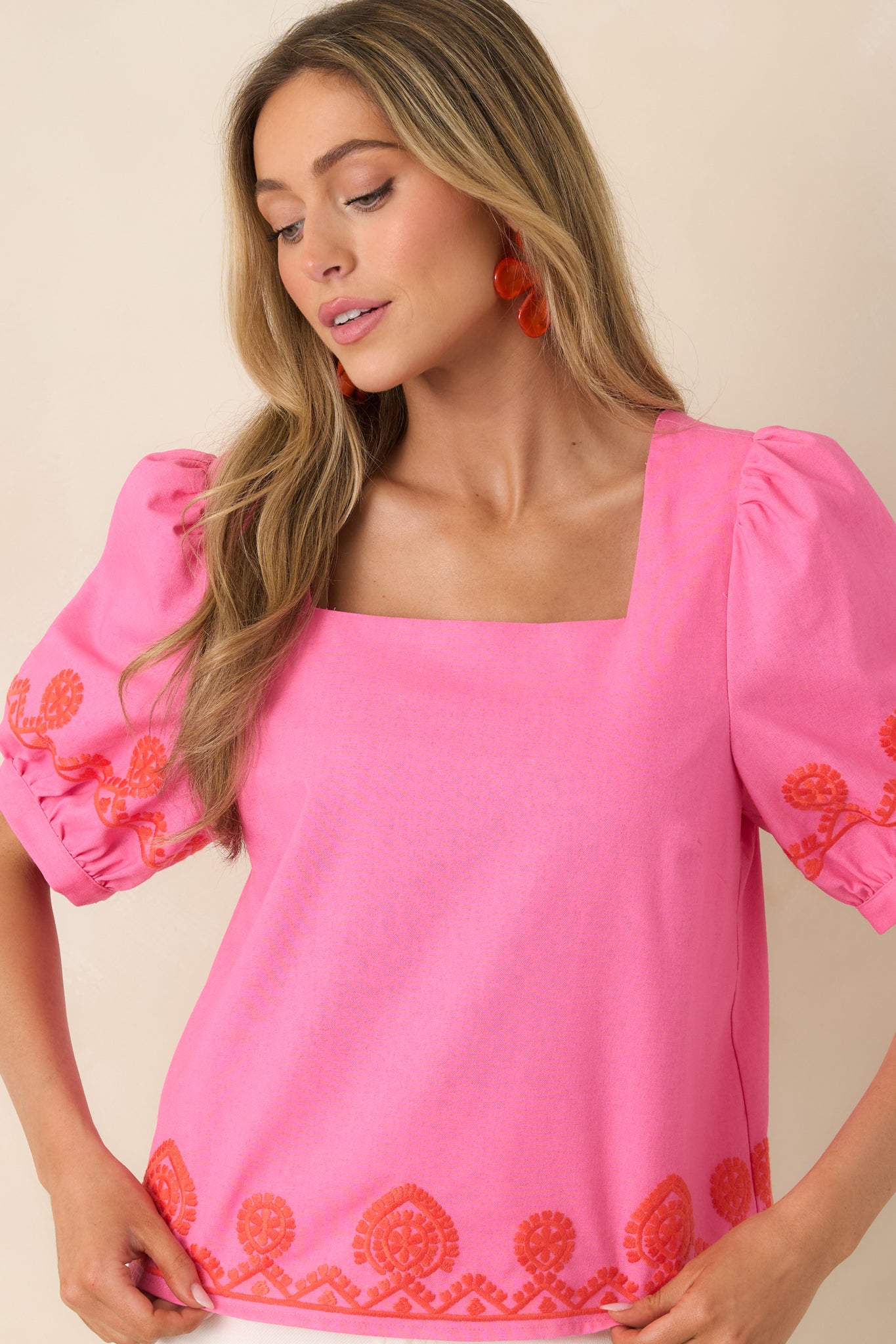 Poppy red embroidery detail along puff sleeve on lightweight, breathable fabric.