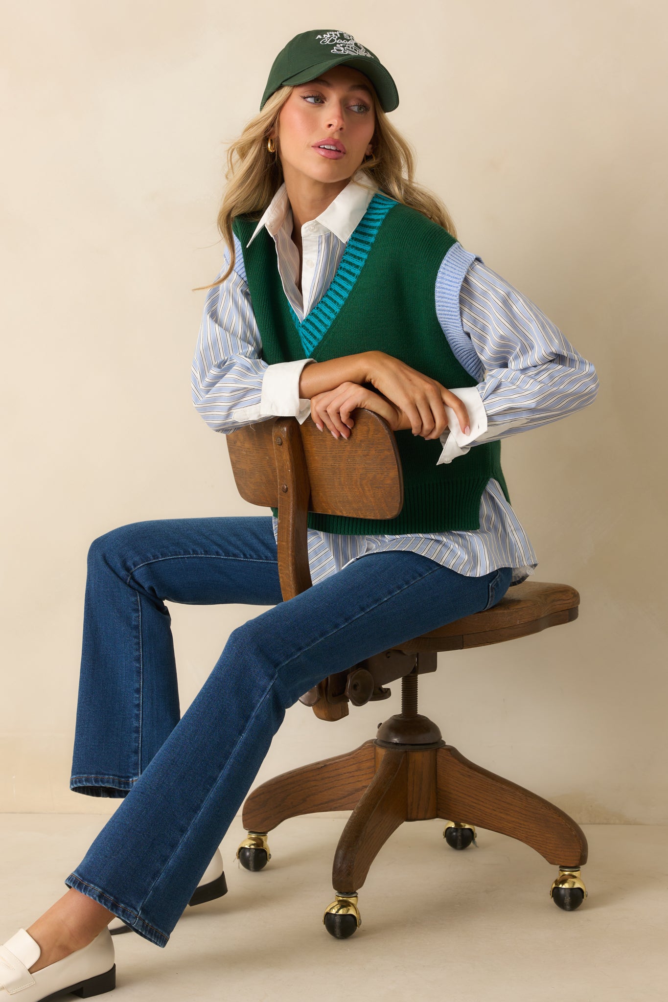 A posed shot of the sweater vest showcasing its casual fit and overall length.