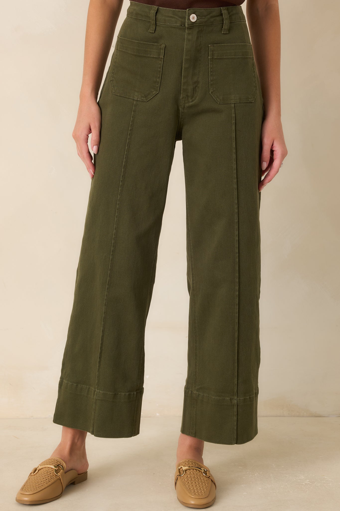 Front detail of the cropped wide-leg pants highlighting the pressed center seams and wide cuff hems.