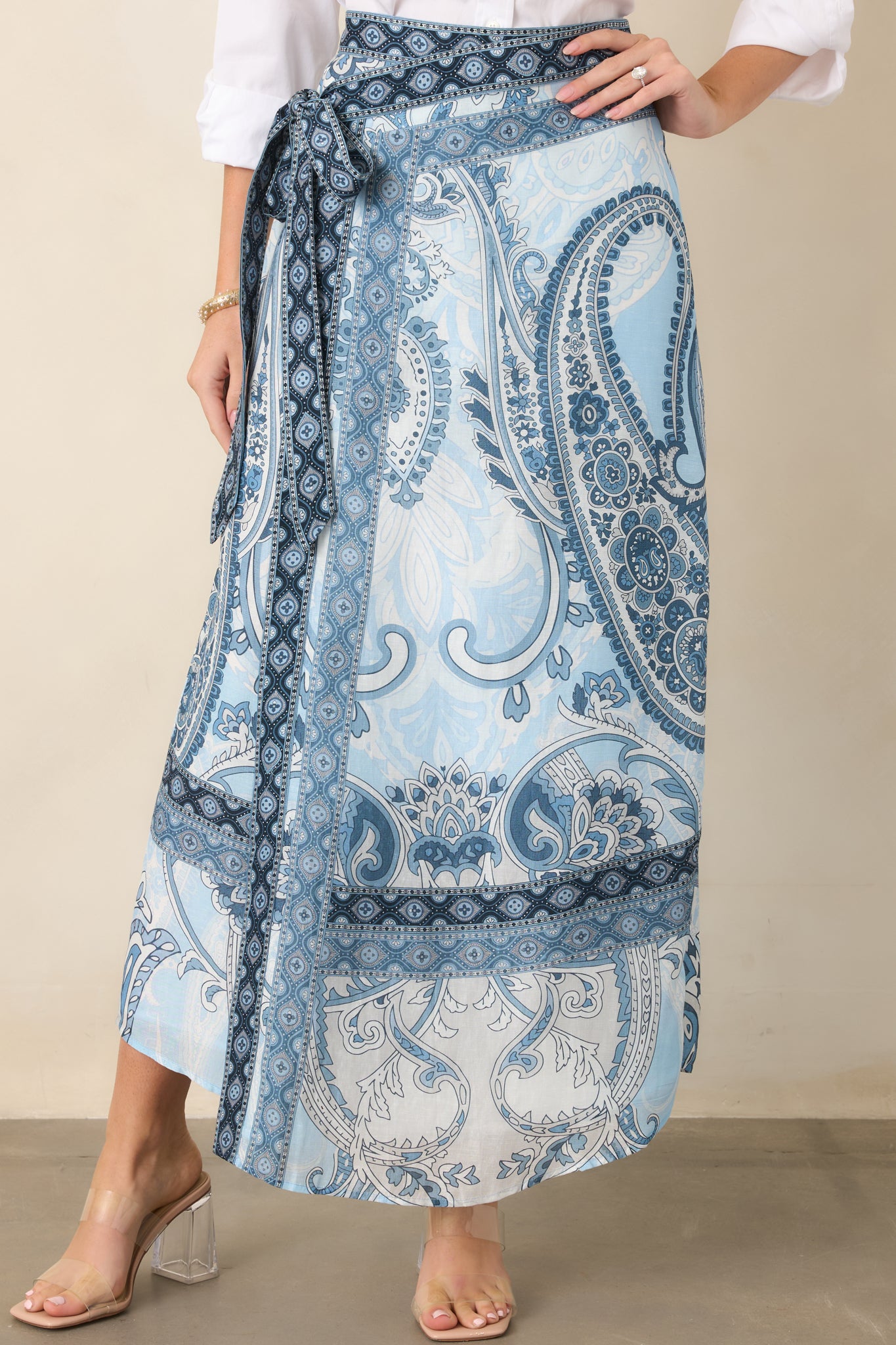 Contrasting border print accents the hem and waist tie, adding a refined patterned finish to the wrap skirt.