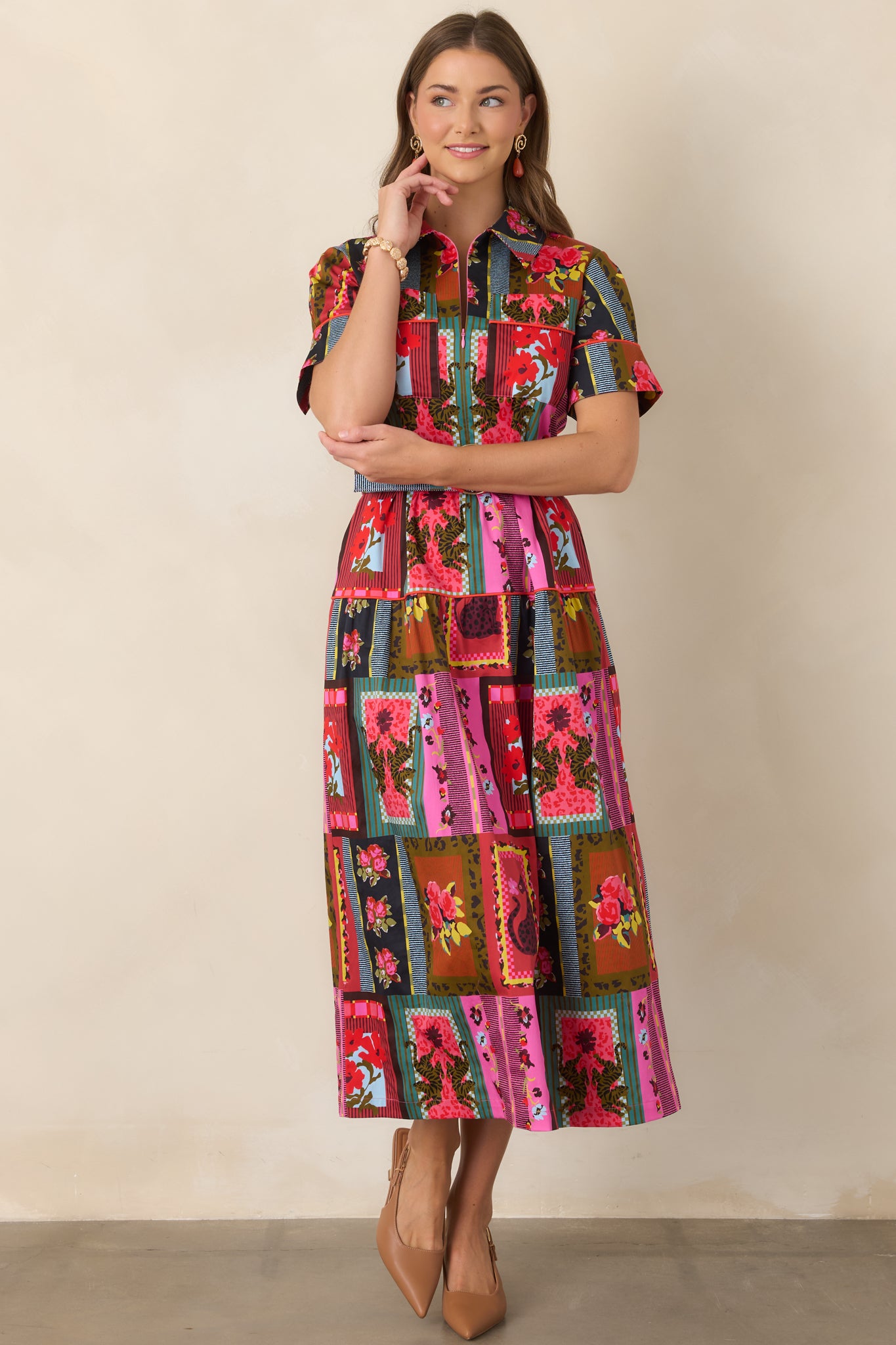 Bold printed ankle-length dress with a crisp collared neckline, detailed sleeve cuffs, contrast trim, covered-buckle belt, and softly flared A-line shape.