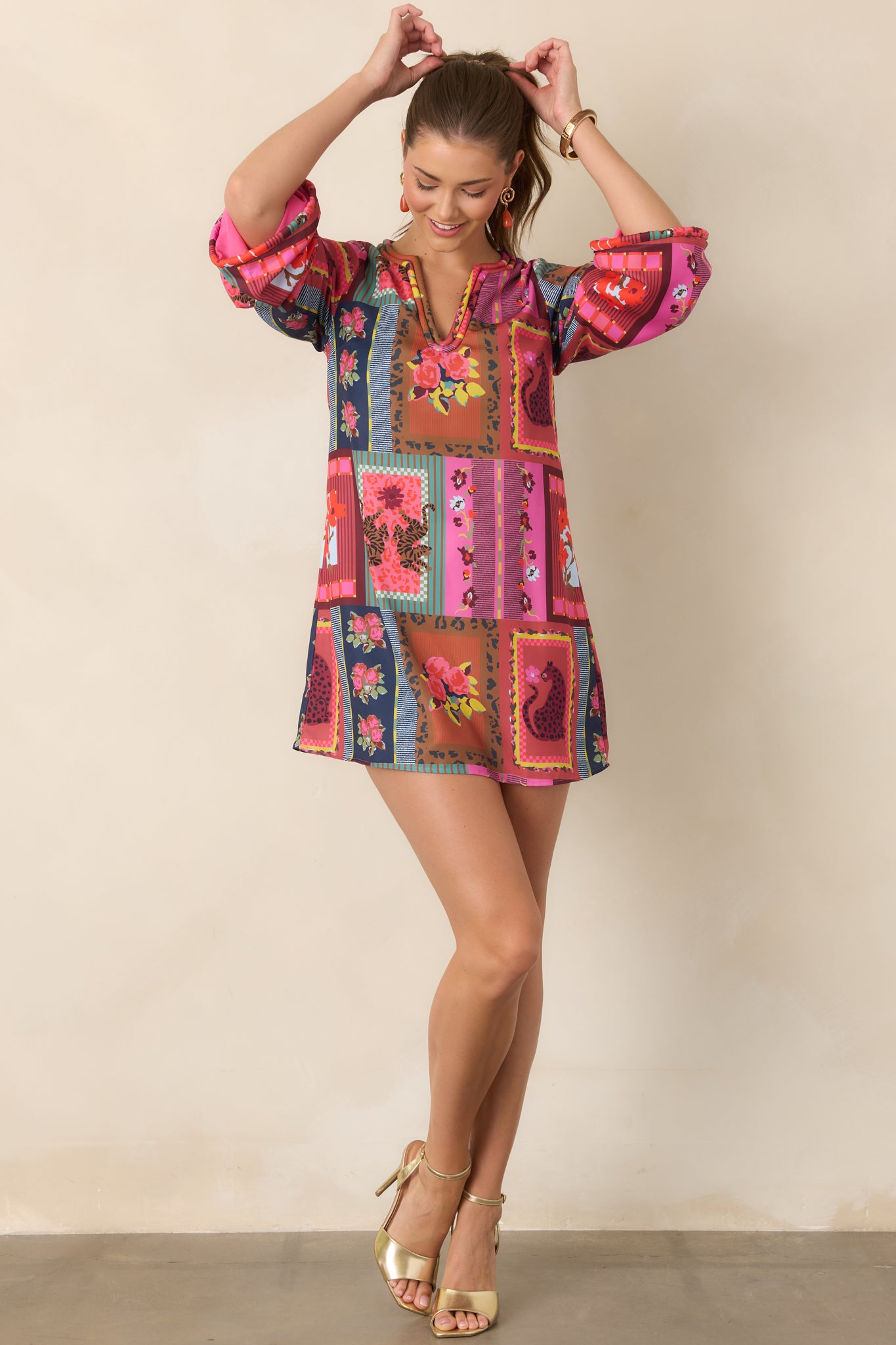 Playful printed mini dress with a softly defined V-neckline, decorative corded edging, roomy three-quarter sleeves, and an above-the-knee hem.