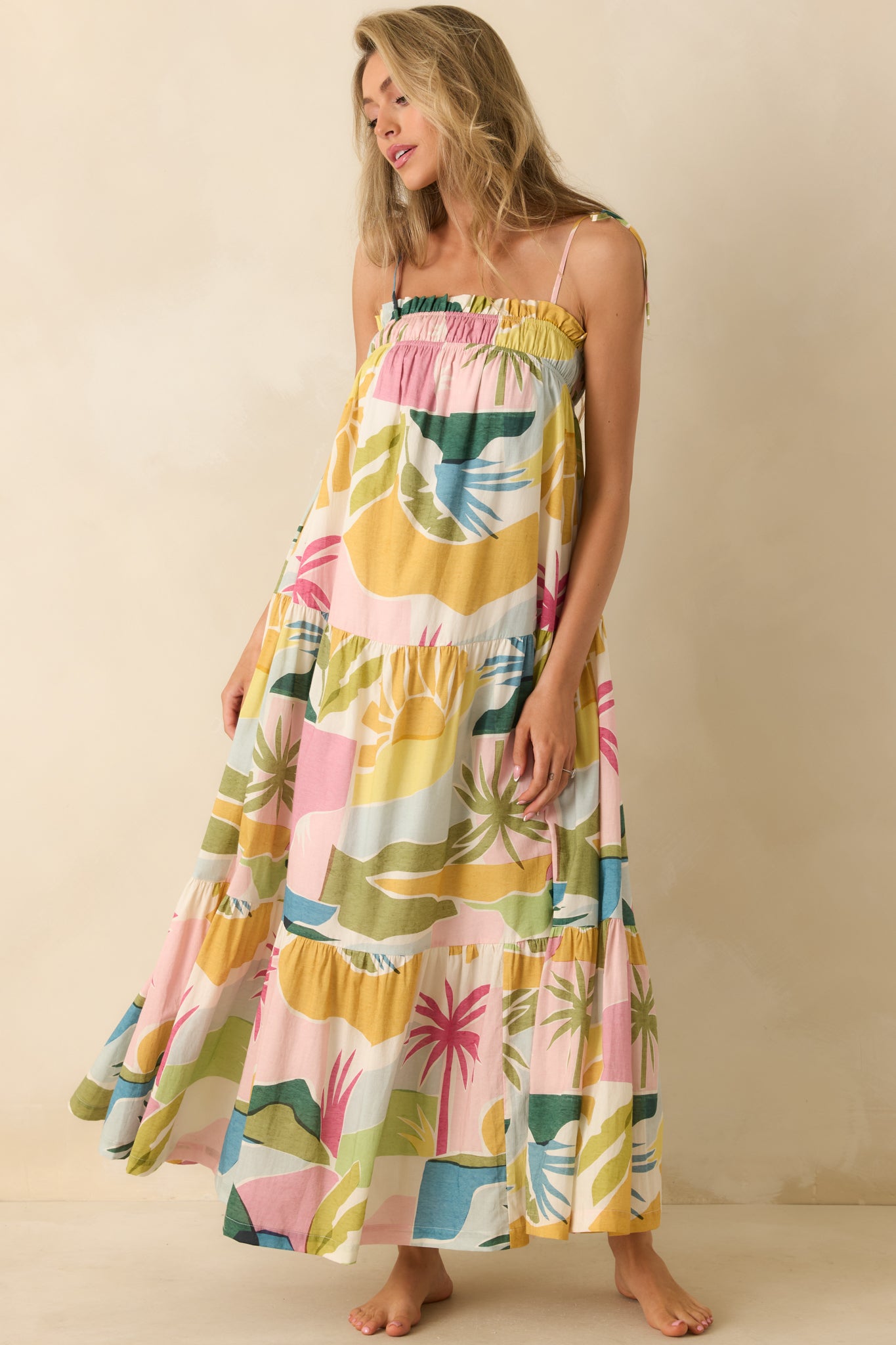 Printed maxi dress with a relaxed silhouette, gathered neckline, tie shoulder straps, and a colorful tropical-inspired design.