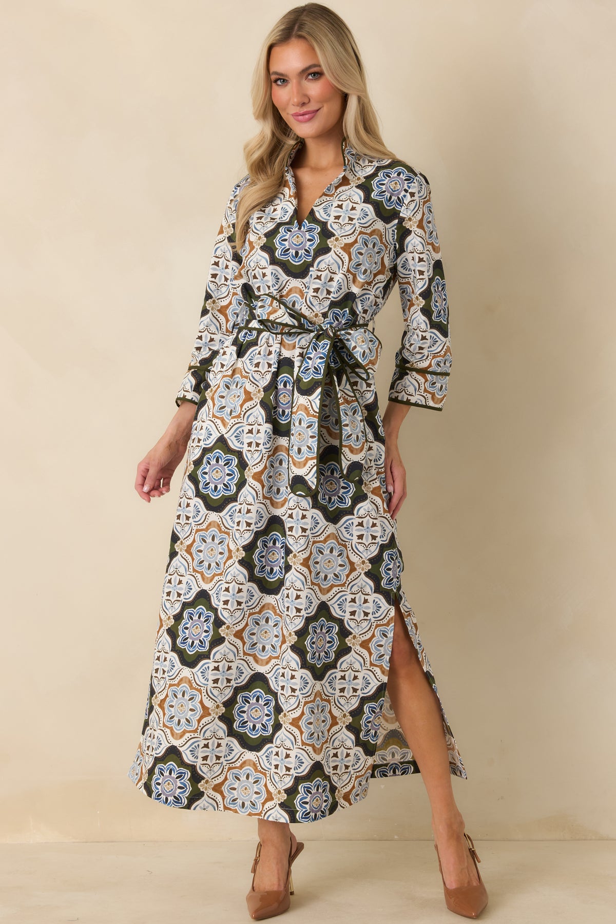 Printed maxi dress with a defined self-tie waist, three-quarter sleeves, olive piping, and a long skirt with a side slit.