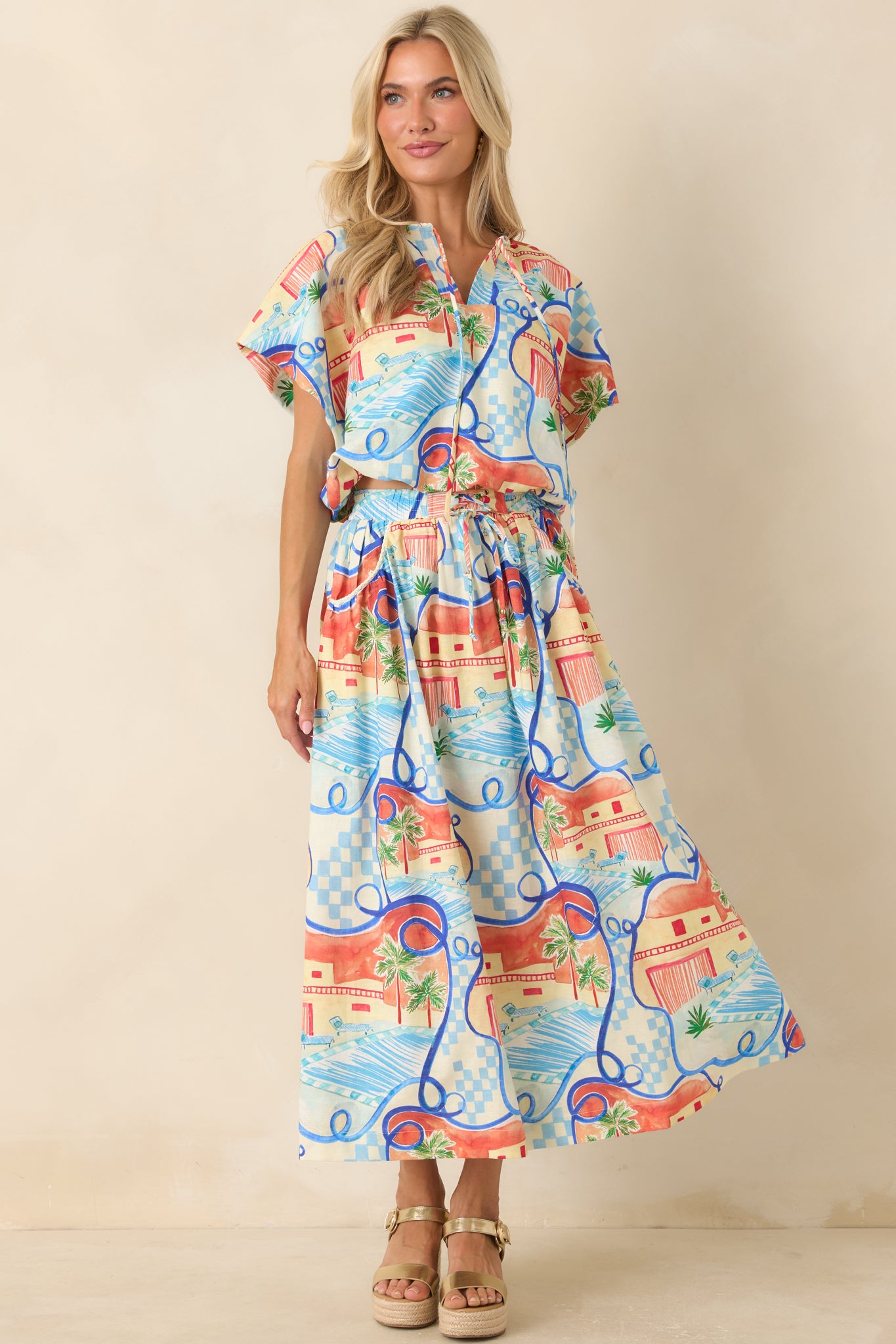 Printed midi skirt showcasing palm trees, geometric details, and a comfortable elastic waistband with an easy fit.