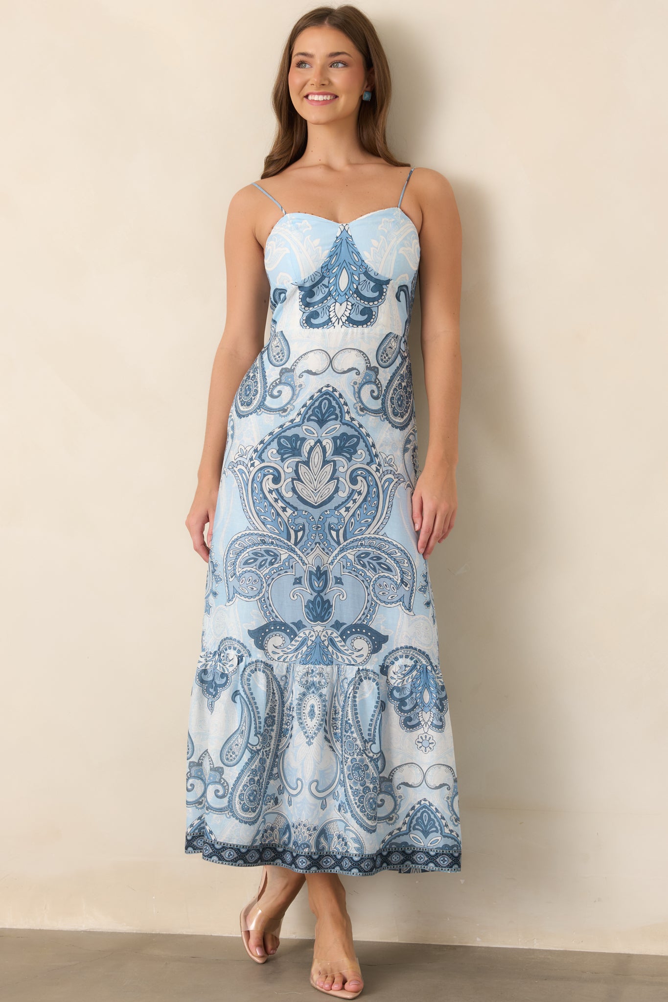 Printed midi dress with delicate wooden bead trim along the neckline, a smocked bodice, and softly flowing tiered skirt.