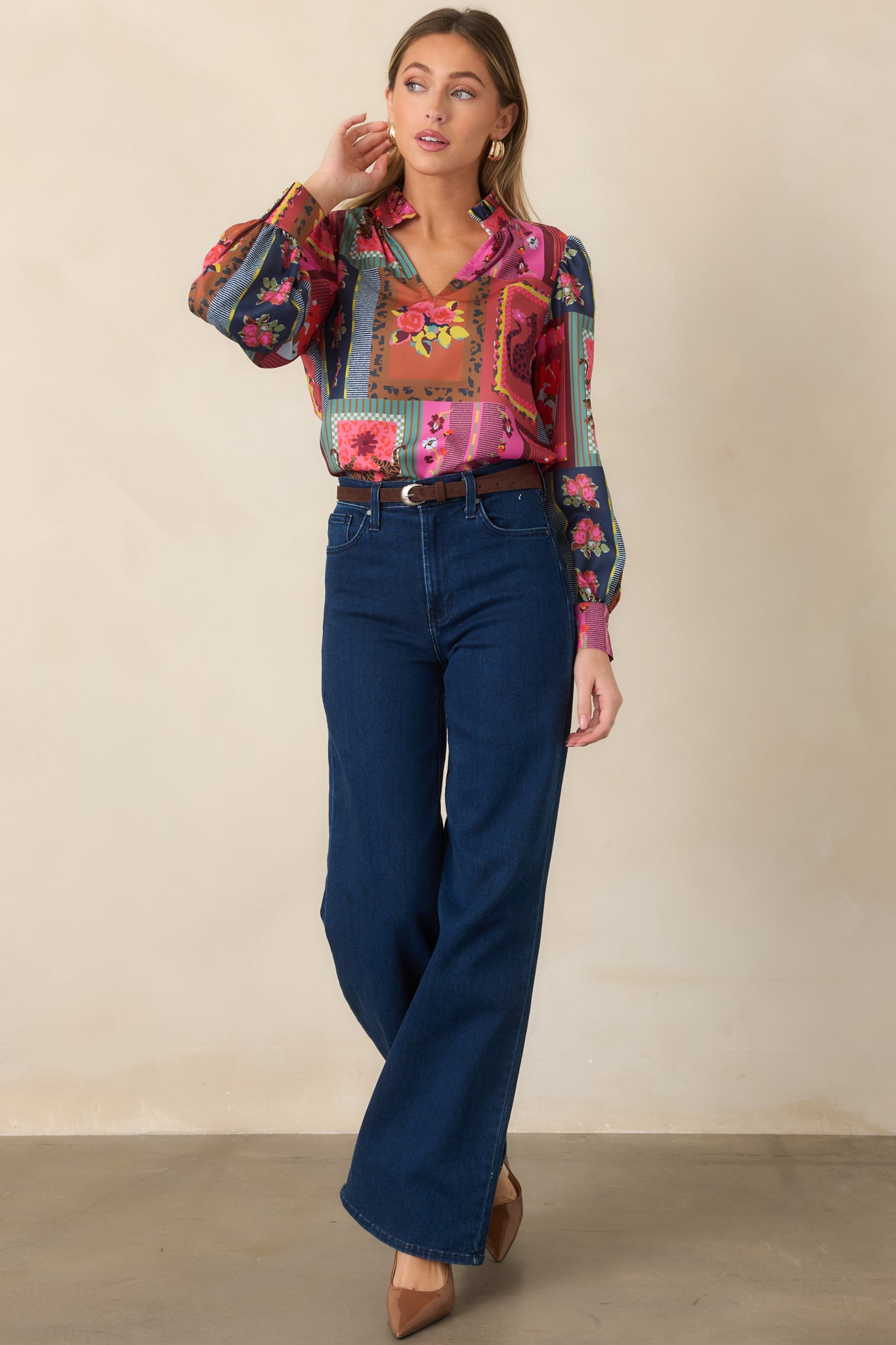 Statement printed top displaying a collected mix of floral patterns, framed motifs, and stripes across its fluid silhouette and voluminous sleeves.