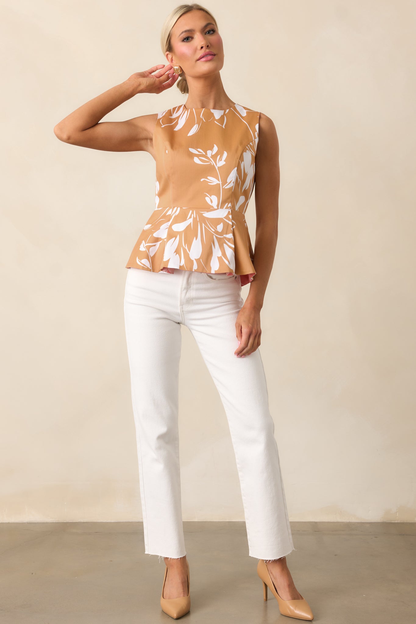 Prosperina sleeveless top showcasing ivory floral pattern on warm brown background.
