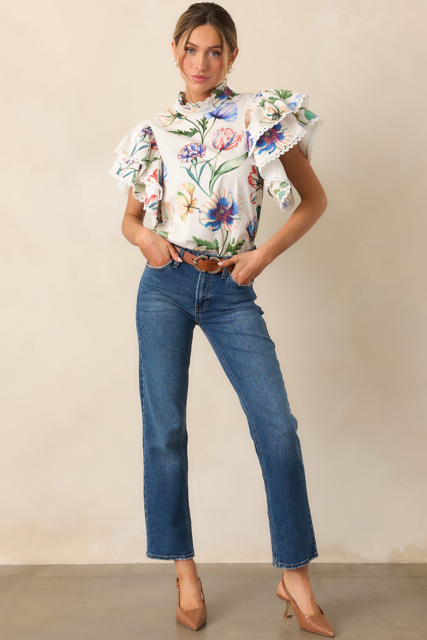 Top with short ruffle sleeves, playful ruffle neckline, and vibrant multicolor floral pattern.