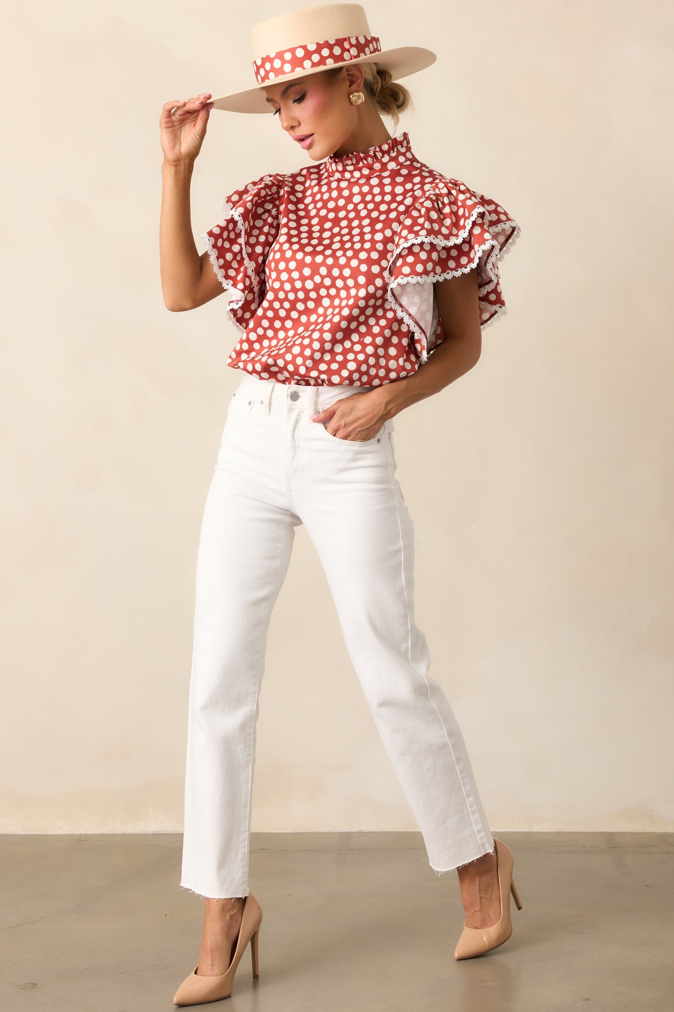 Polka dot top with a ruffle mock neckline and airy, short ruffle sleeves.
