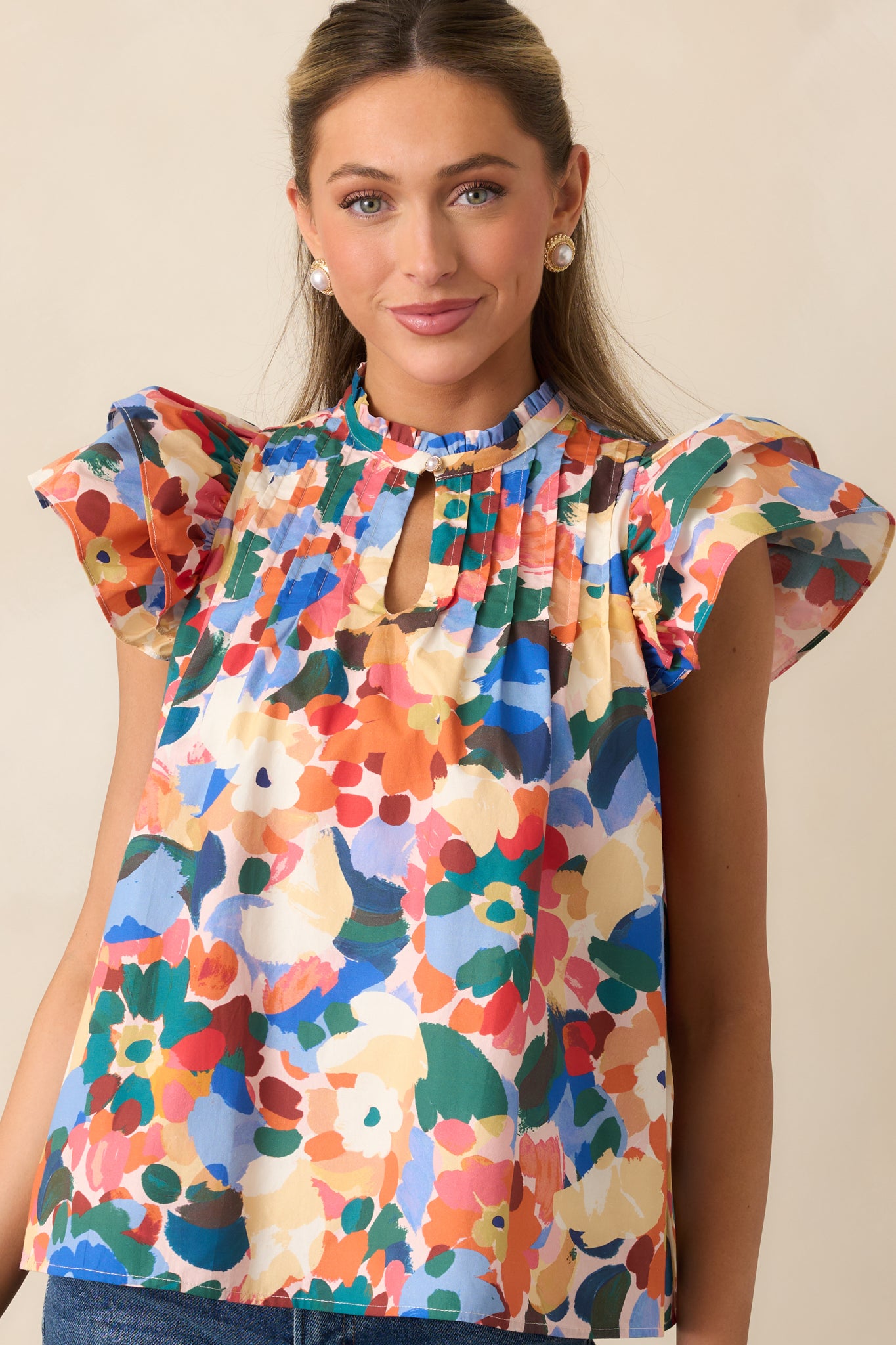 Close view of the ruffle mock neckline and front keyhole closure.