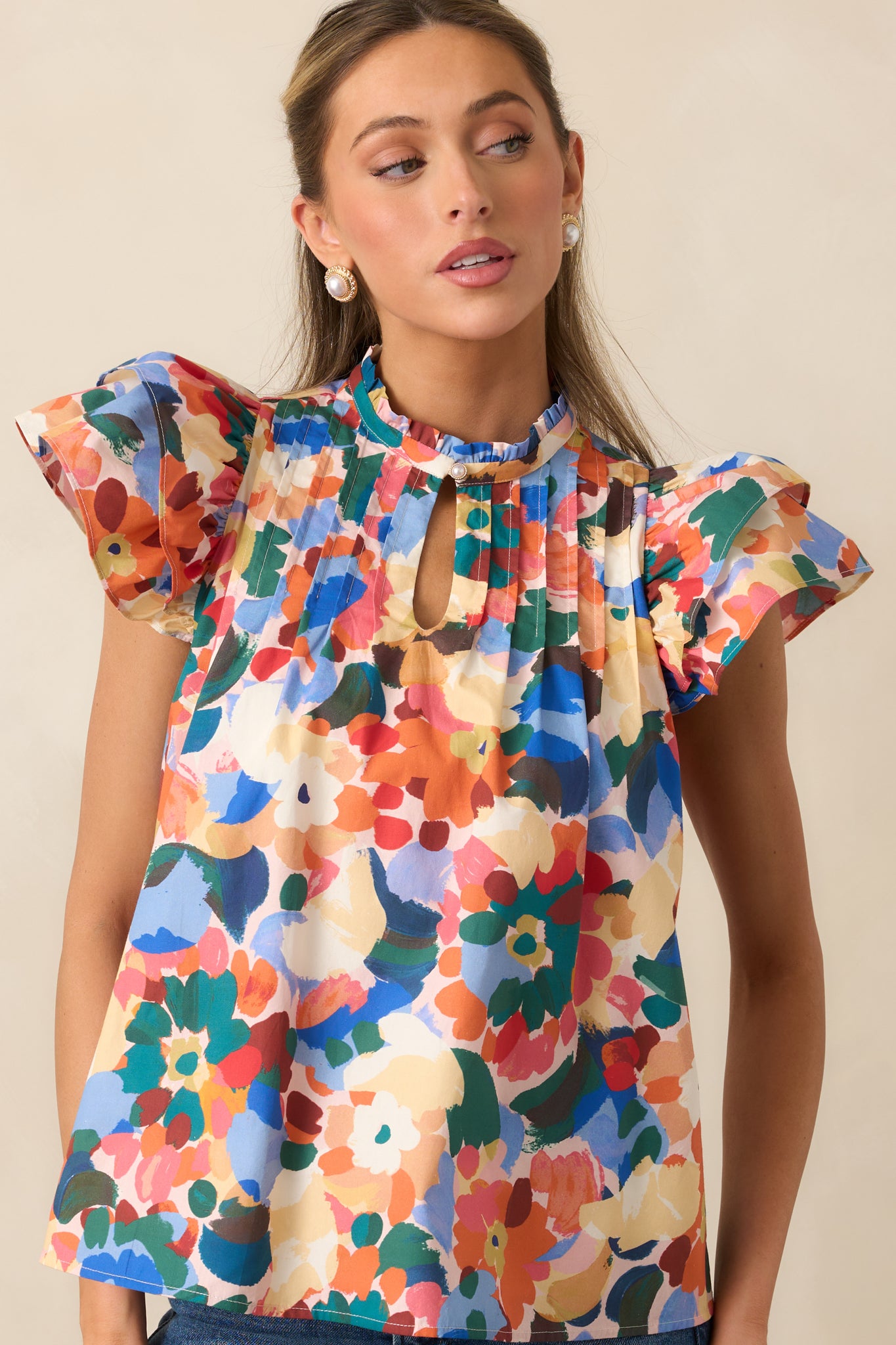 Cropped front view showing the multicolor floral print and delicate ruffle accents.