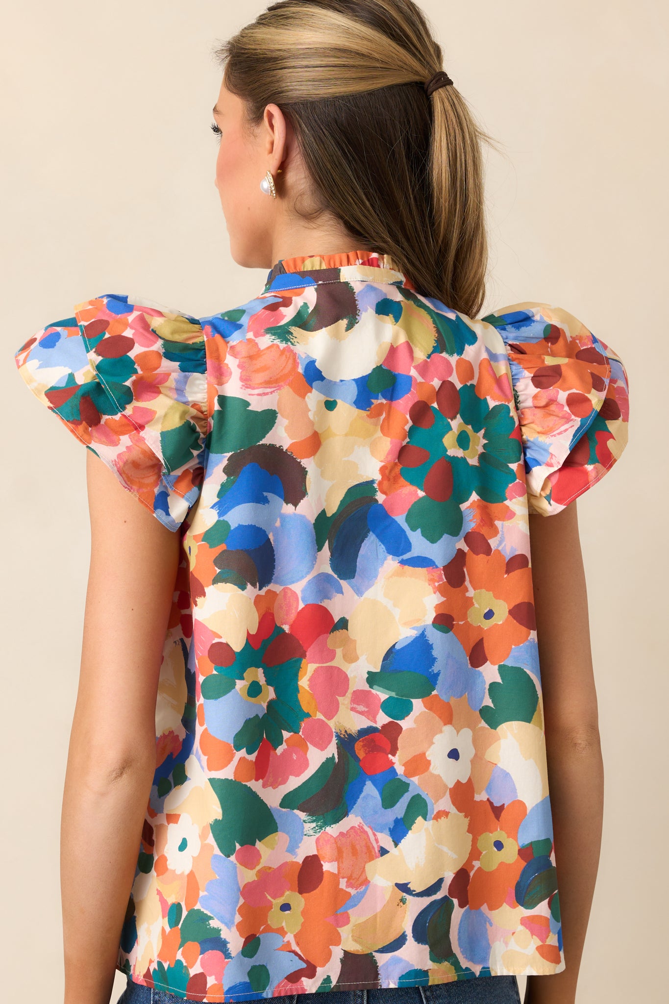 Rear view of the top showing short flutter sleeves and relaxed silhouette.