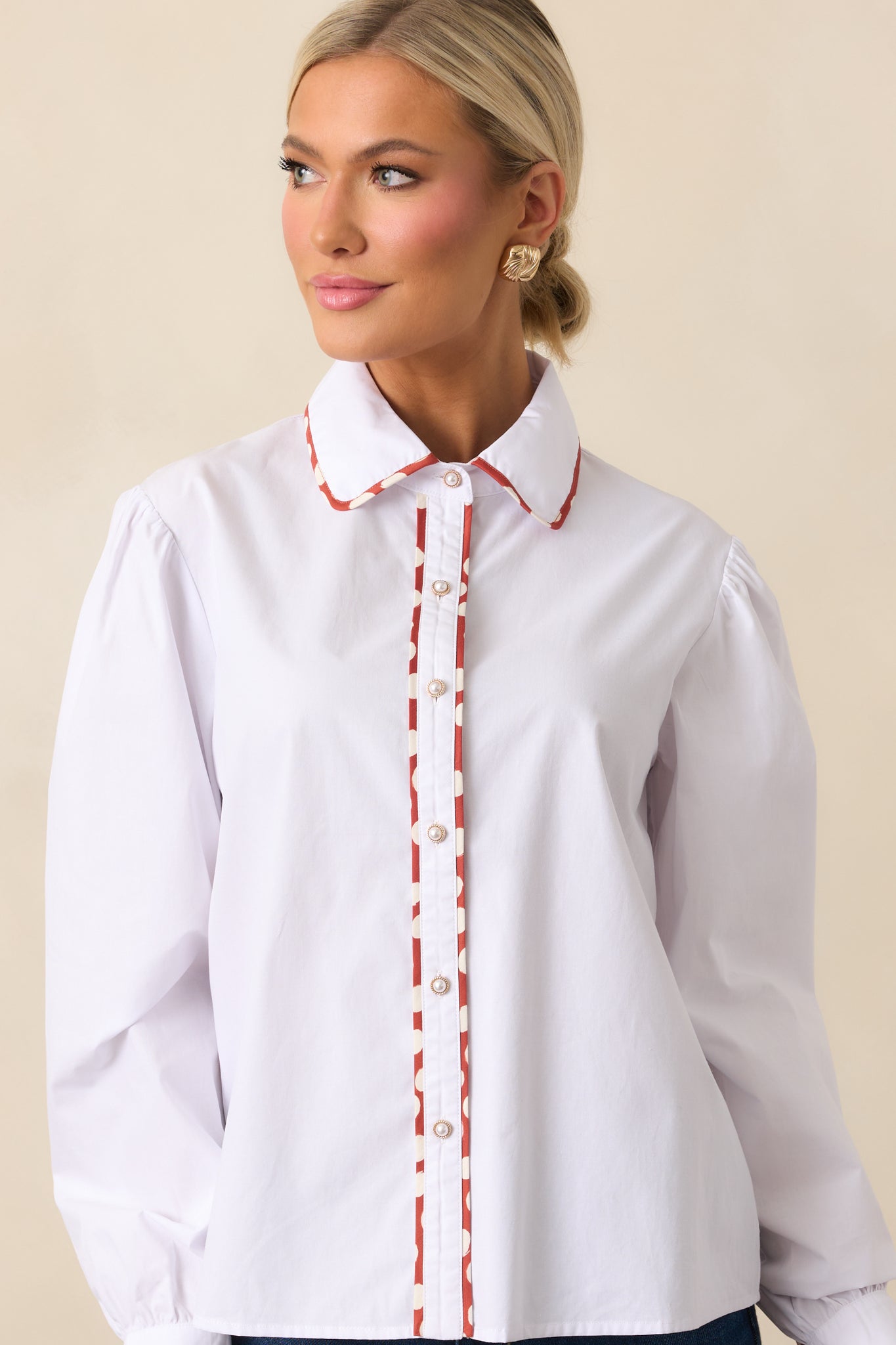 Cropped view of the functional button front and relaxed fit of the top.