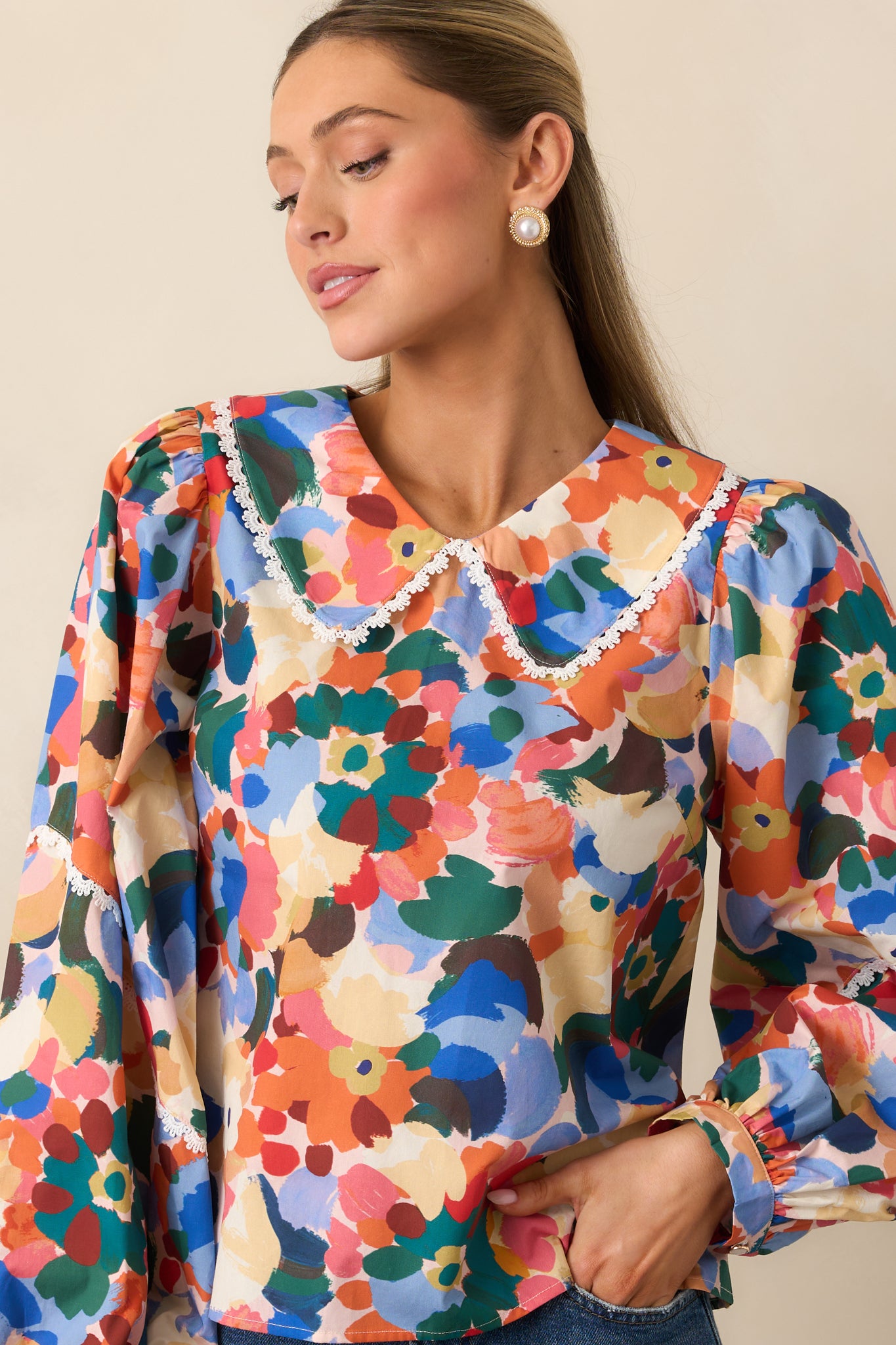 Front detail of the relaxed-fit orange floral top with subtle lace accents.