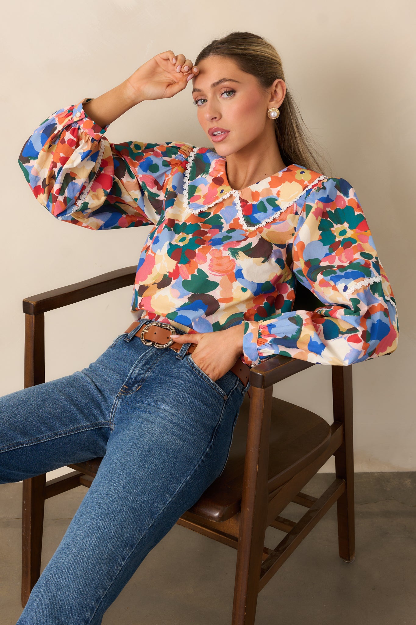 Cropped view showing the floral print, puff sleeves, and delicate trim.
