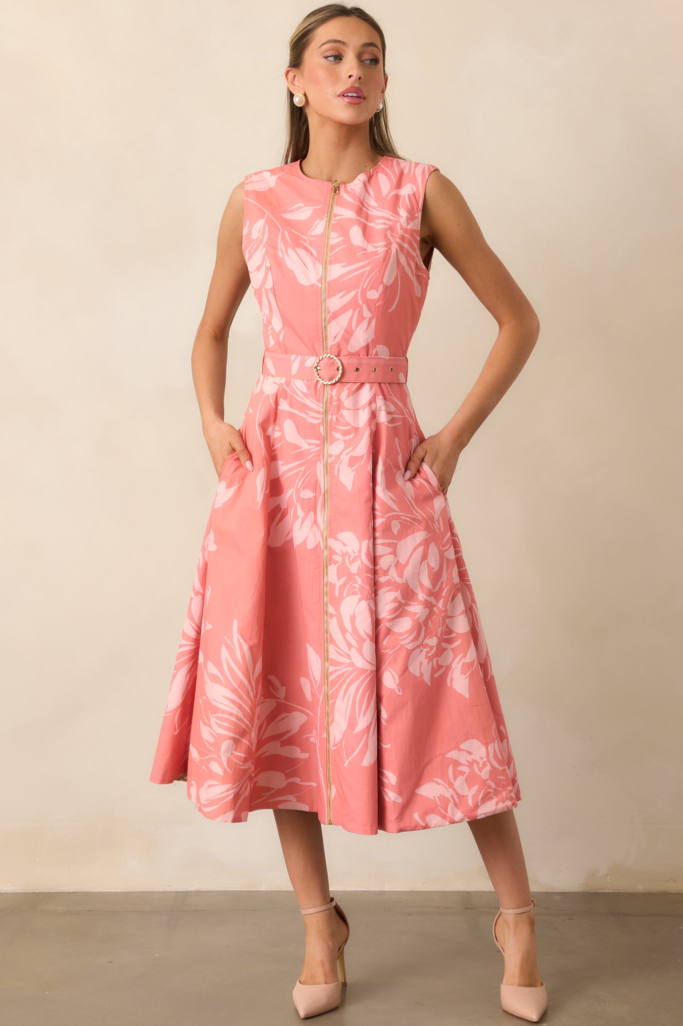 Pink floral sleeveless midi dress highlighting delicate florals and relaxed fit.