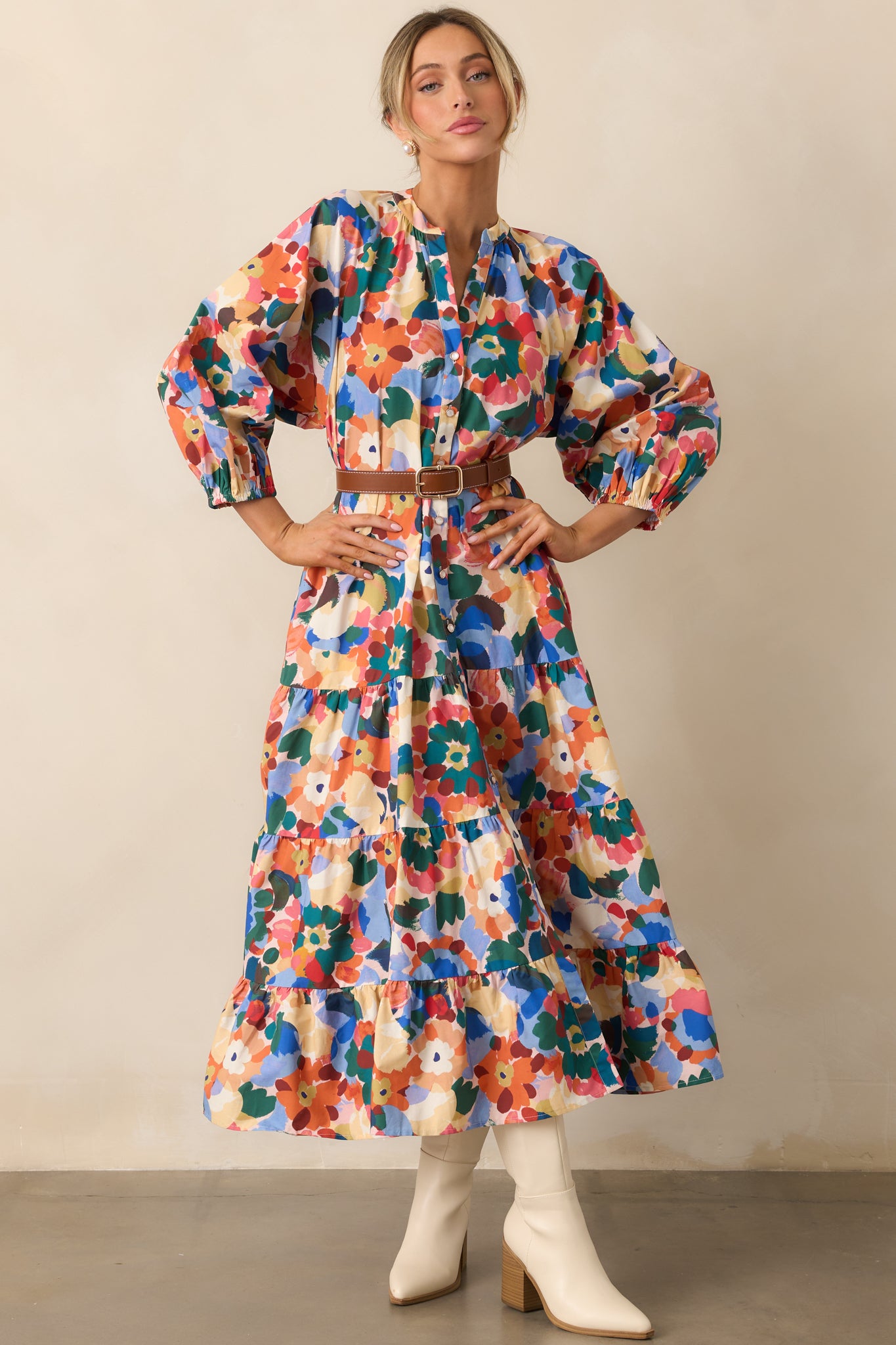 Long-sleeve floral maxi dress featuring puff sleeves with elastic cuffs and a flowing tiered skirt.