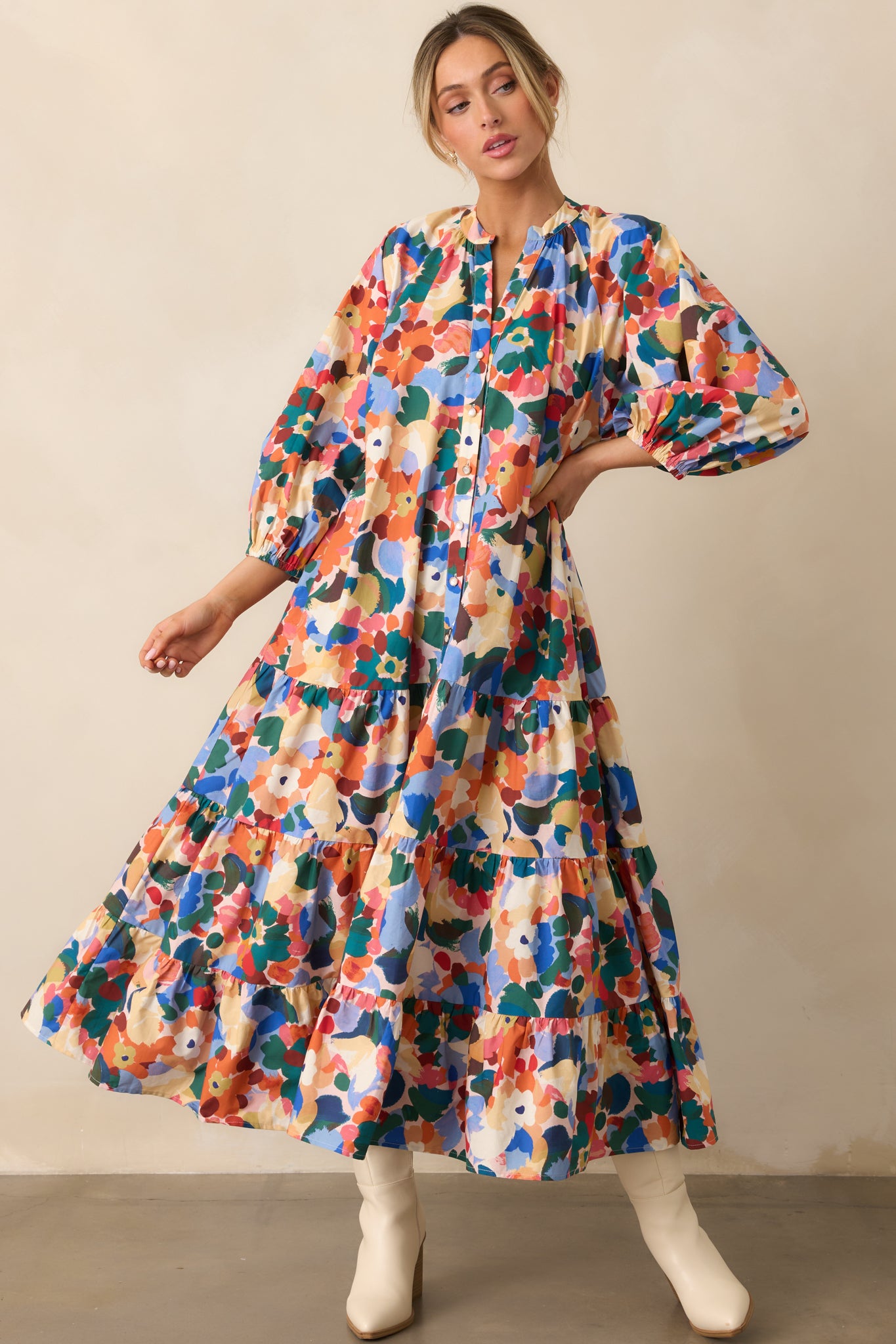 Colorful floral maxi dress showcasing long puff sleeves, notch v-neck, and playful tiered layers.