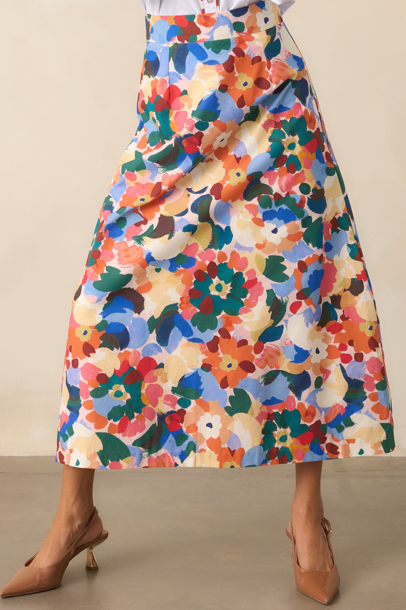Midi skirt with vibrant orange floral print showing smooth lining and structured waist