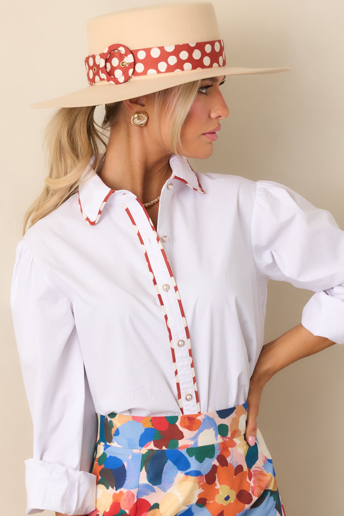 White top with rust red and ivory detailing, showcasing a structured yet relaxed silhouette.