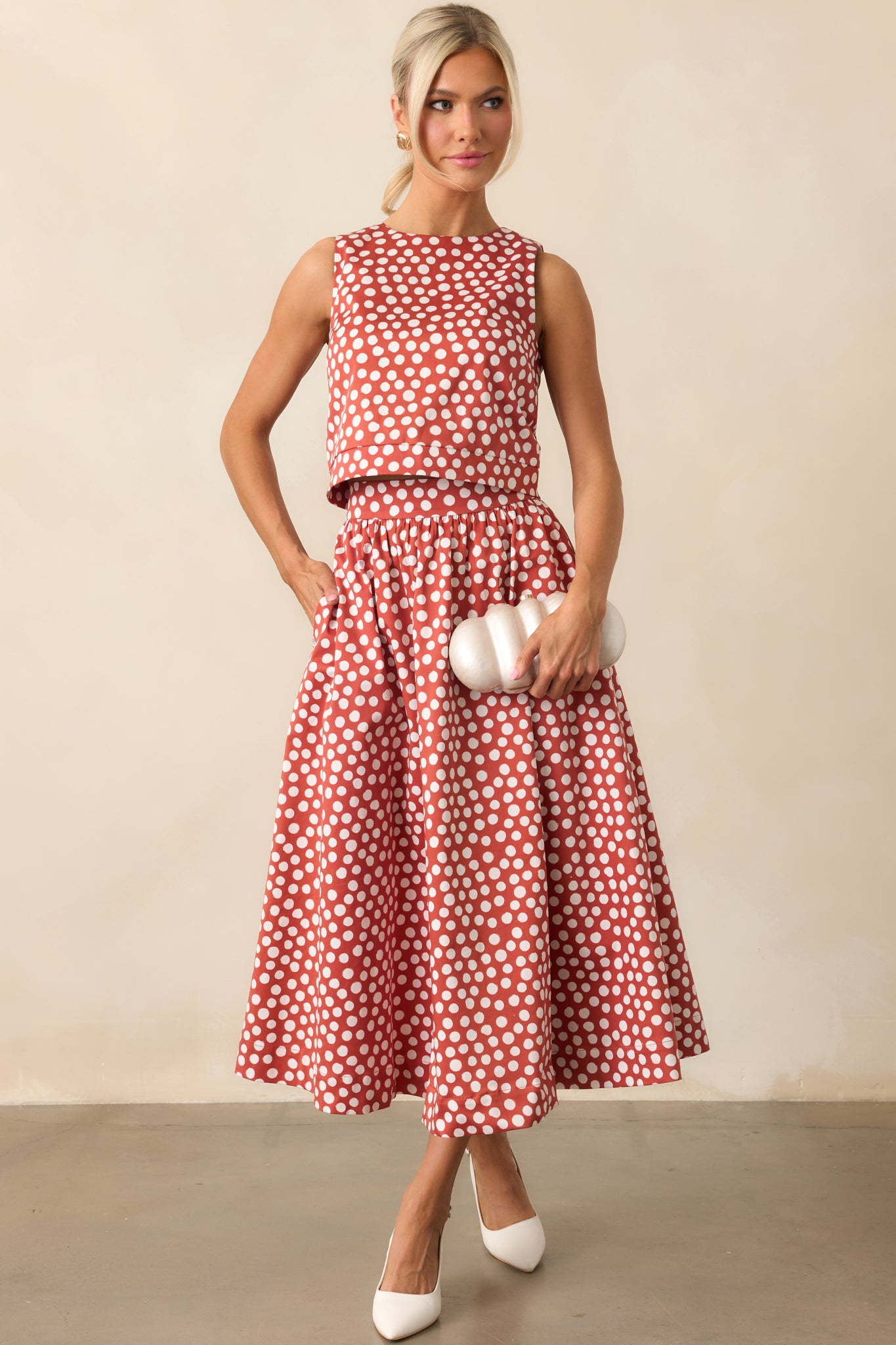 Polka dot midi skirt with functional pockets and a softly flowing silhouette.