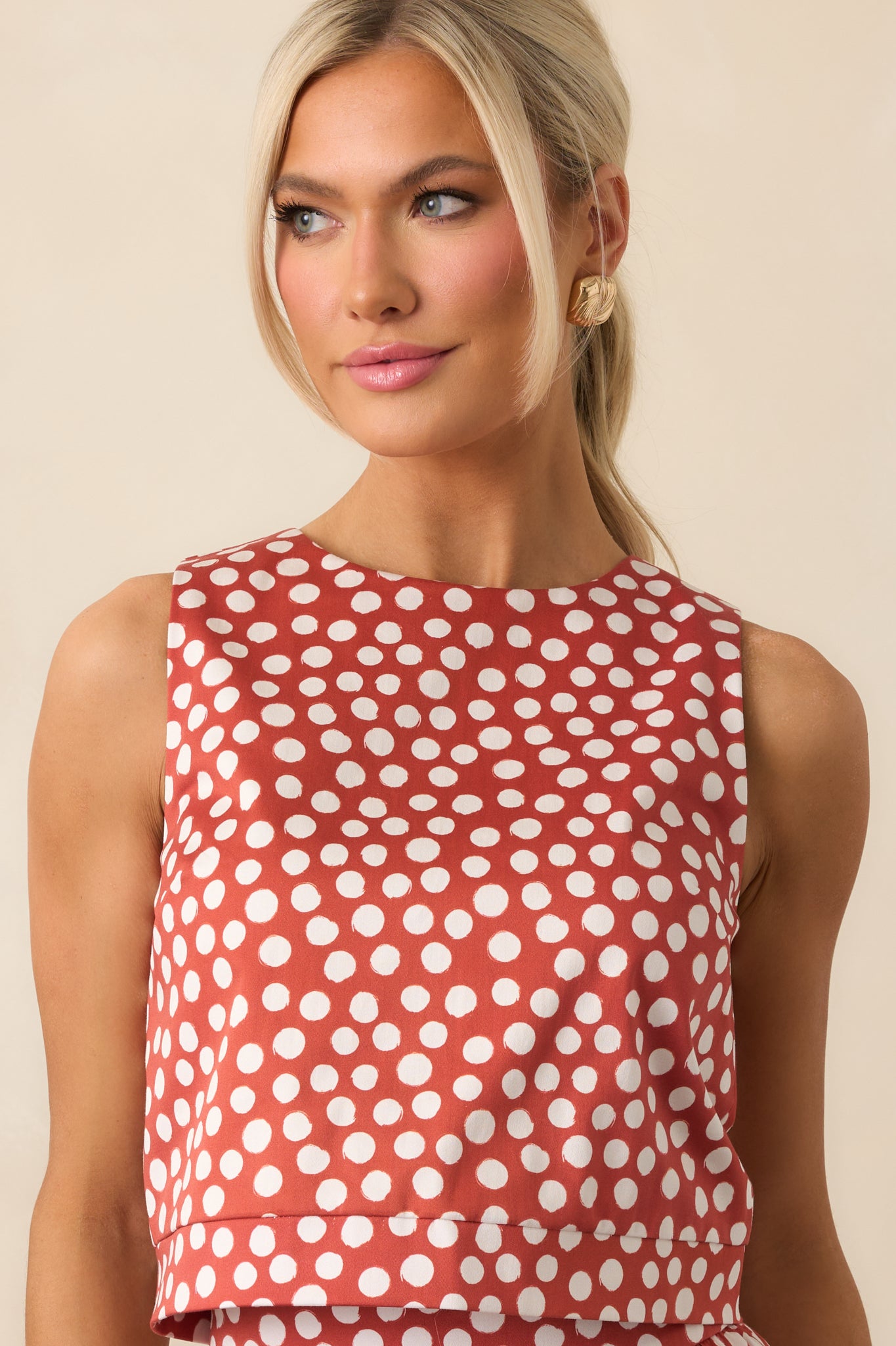 Cropped-length polka dot top showing off the tailored silhouette.