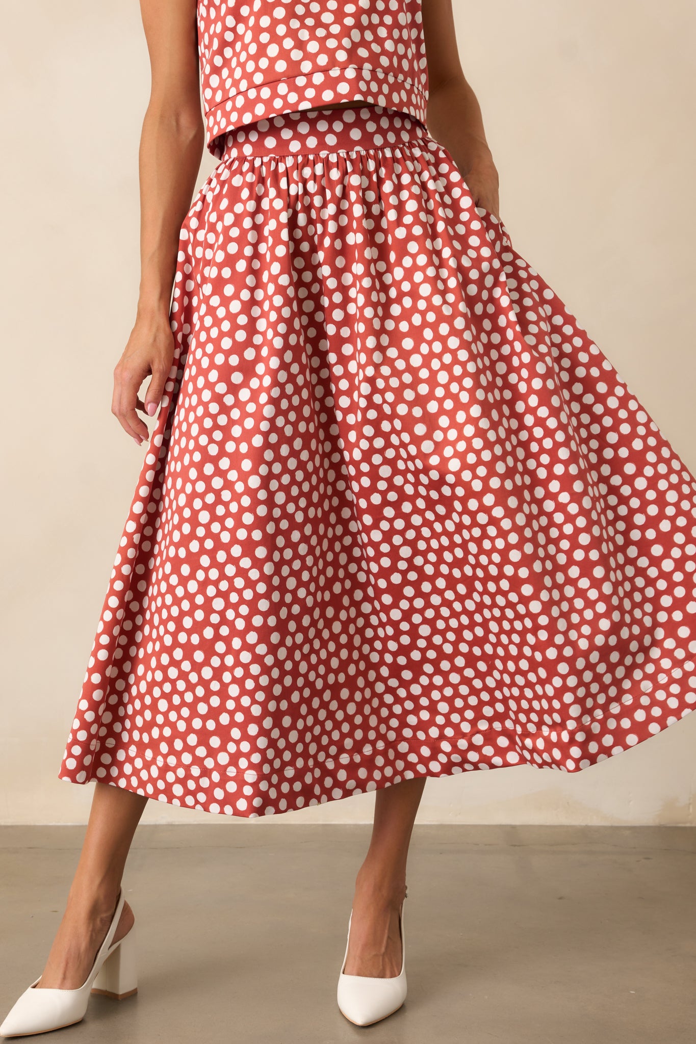 Polka dot skirt in a midi length with smooth fabric and functional pocket detail.
